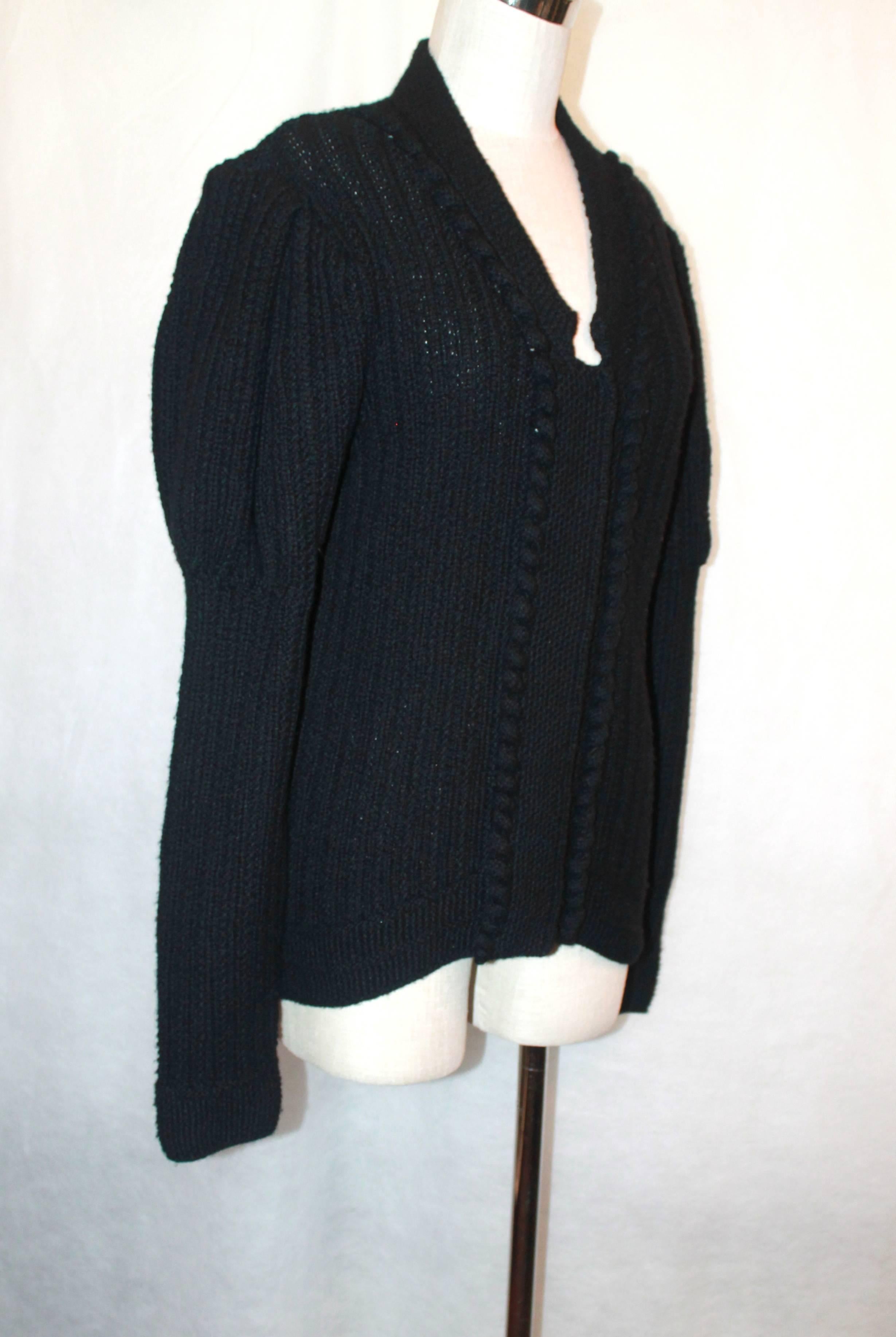 Oscar de la Renta Black Cashmere Knitted Heavy Sweater - Large.  This sweater is in excellent condition.  It has snap buttons and slight poof on the sleeve.  This sweater is a heavier knit.

Measurements:
Bust: 20.5