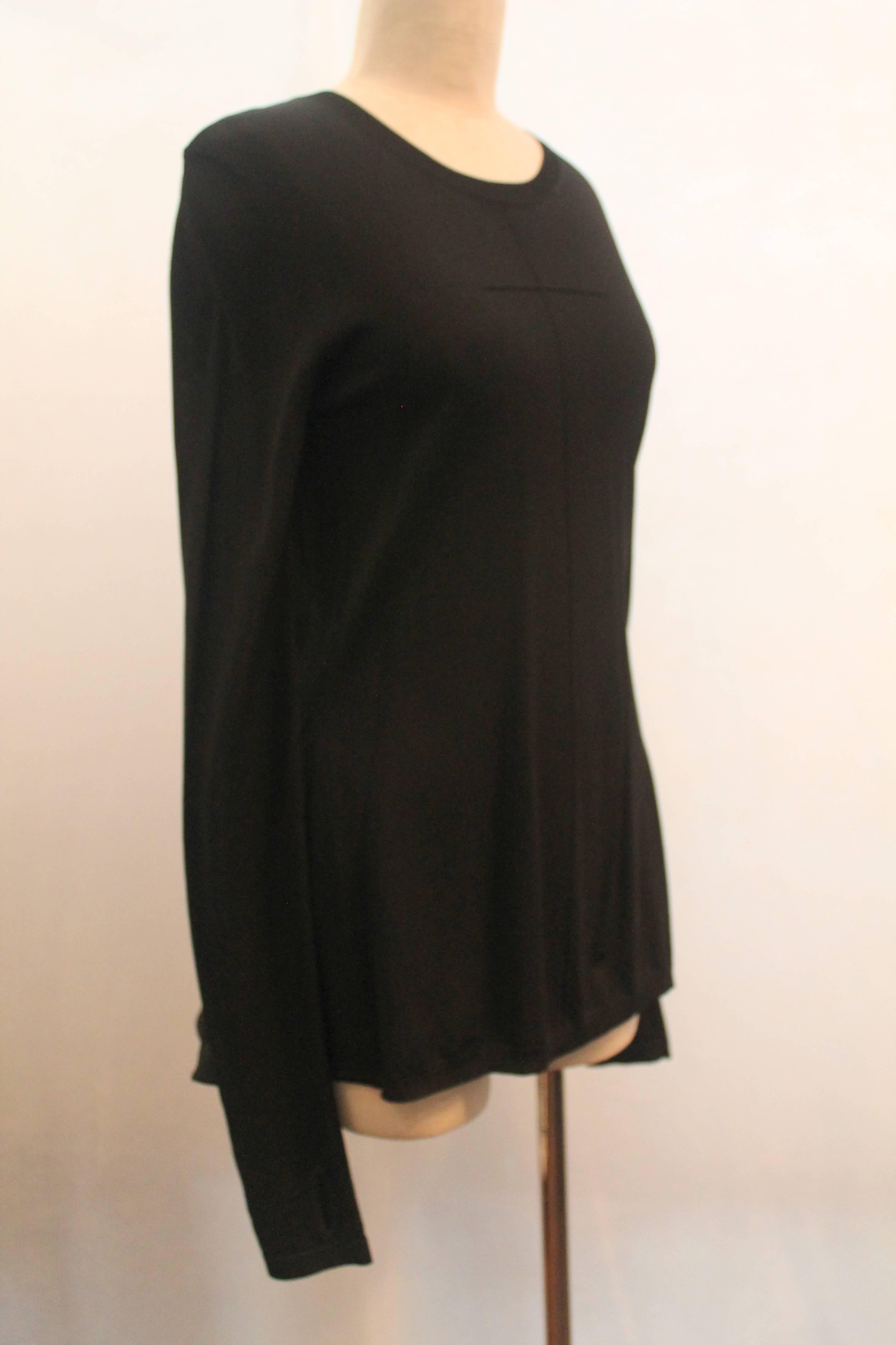 Givenchy Black Long Sleeved Sweater w/ Peplum Back - Medium.  This long polyester sweater has hand inserts at the cuffs and one front pleat.  The back has a slight peplum.  It is in excellent condition.

Measurements:
Bust: 33.5