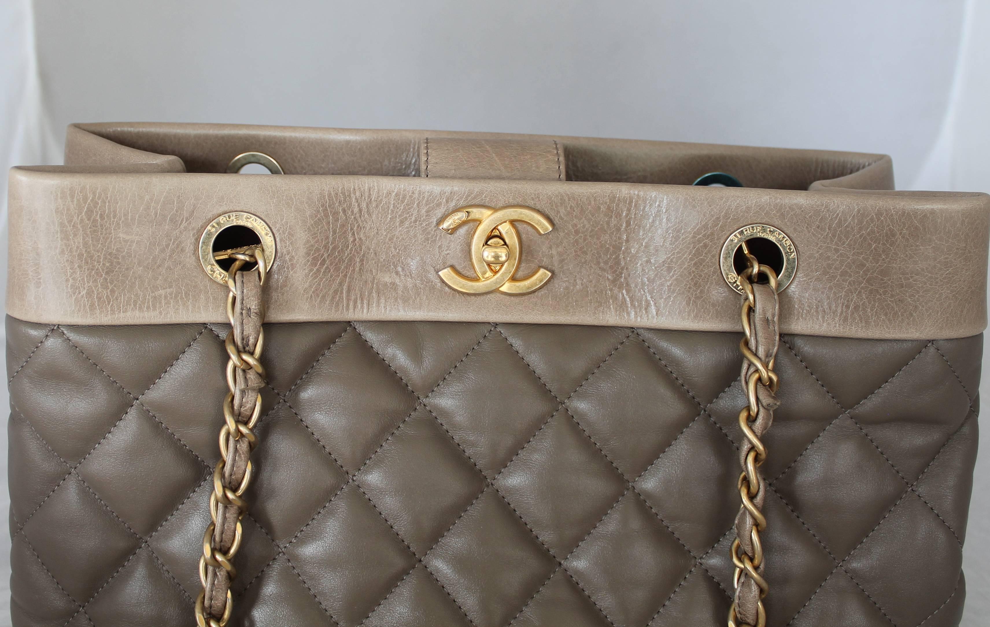 Chanel 2013 Taupe Soft Elegance Tote Shoulder Bag - GHW. This quilted bag is in excellent condition  and has a plum colored lining. It comes with the duster and box. It has 3 different compartments with the center section having a zipper. The
