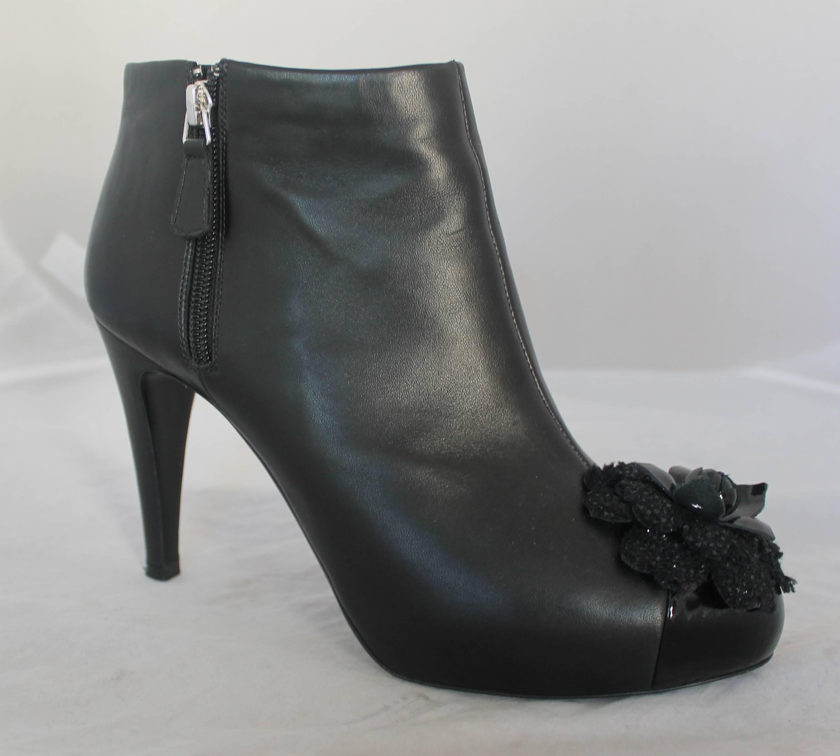 Chanel Black Leather Heeled Booties with Front Camellia - 40

These shoes are in excellent with very minor wear on the bottoms. They are leather with zippers on both sides of the shoe and have a camellia at the tip of the shoe. The flower is made