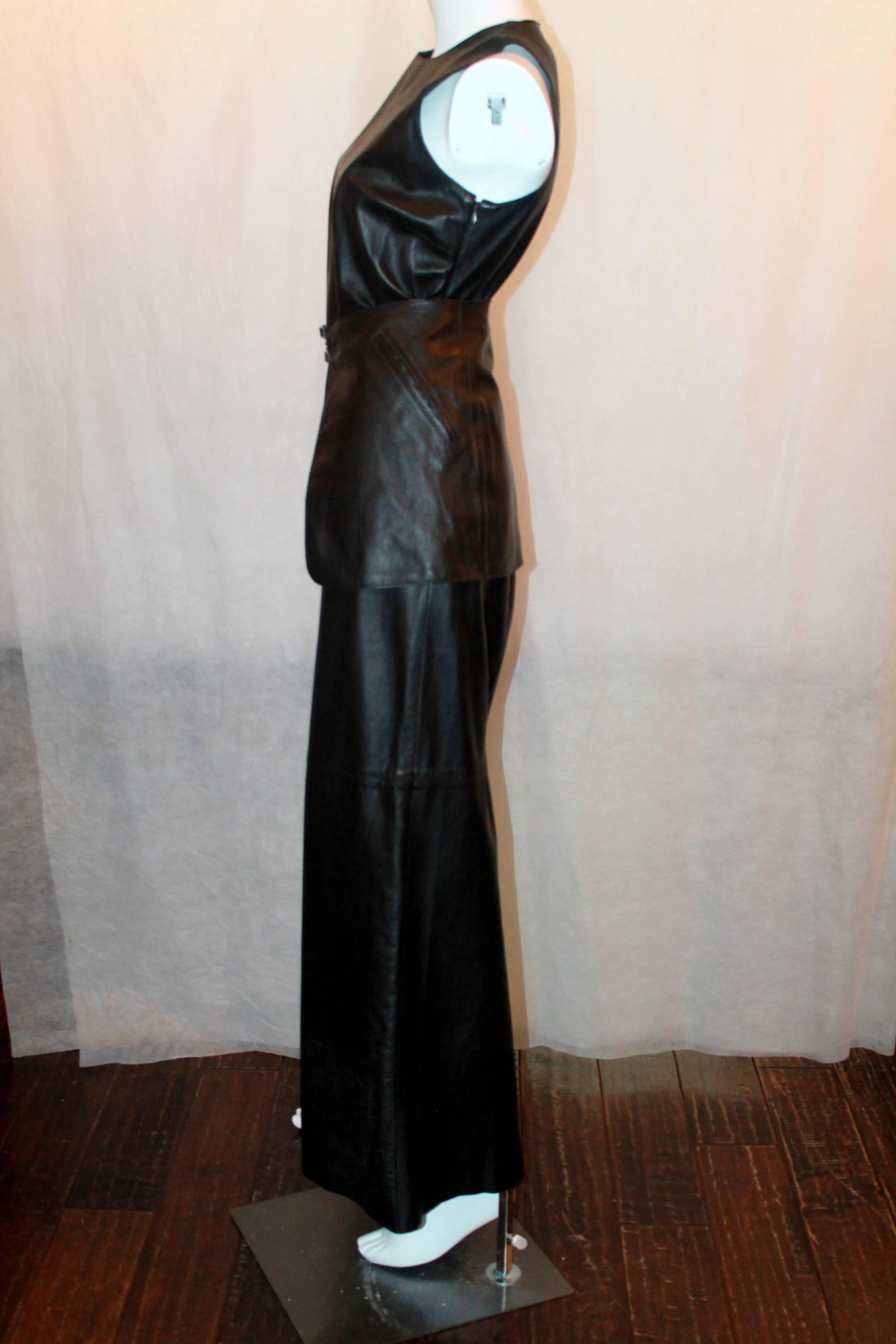 John Bartlett 1990's Vintage Leather Chocolate Brown Long Dress with Skirt Belt - 42. This maxi dress is in excellent condition and comes with a matching skirt-style wide belt (images 1-3). It is sleeveless, has a round neck, side zip, and back