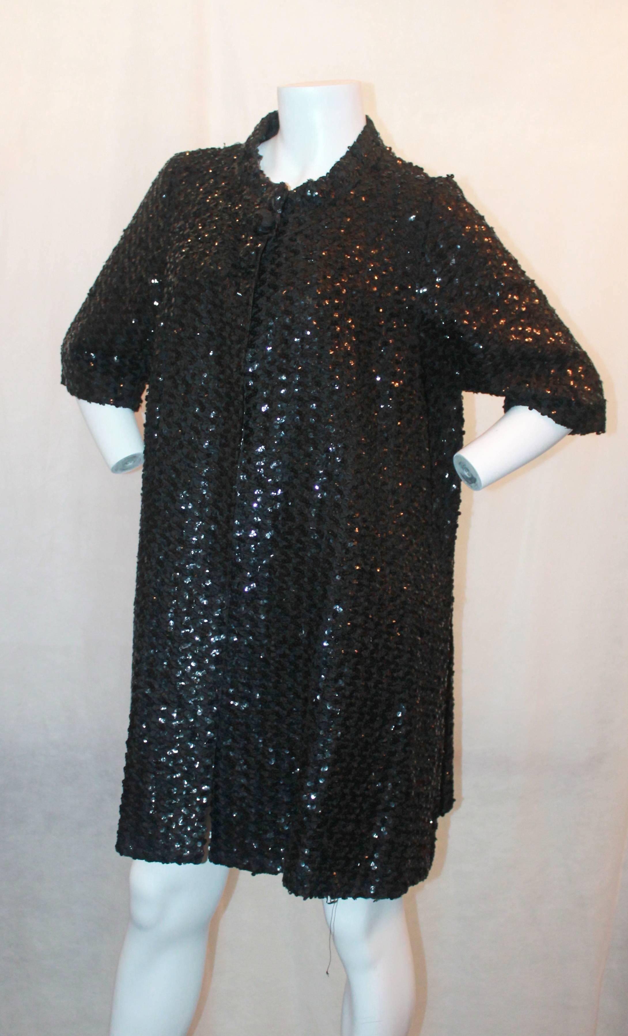 1960's Vintage Black Sequin 3/4 Coat - S. This piece is in excellent condition and is a swing coat with front snaps and 2 sequin ball buttons. It is a gorgeous piece and has a 3/4 sleeve.

Measurements:
Shoulder to Shoulder- 15