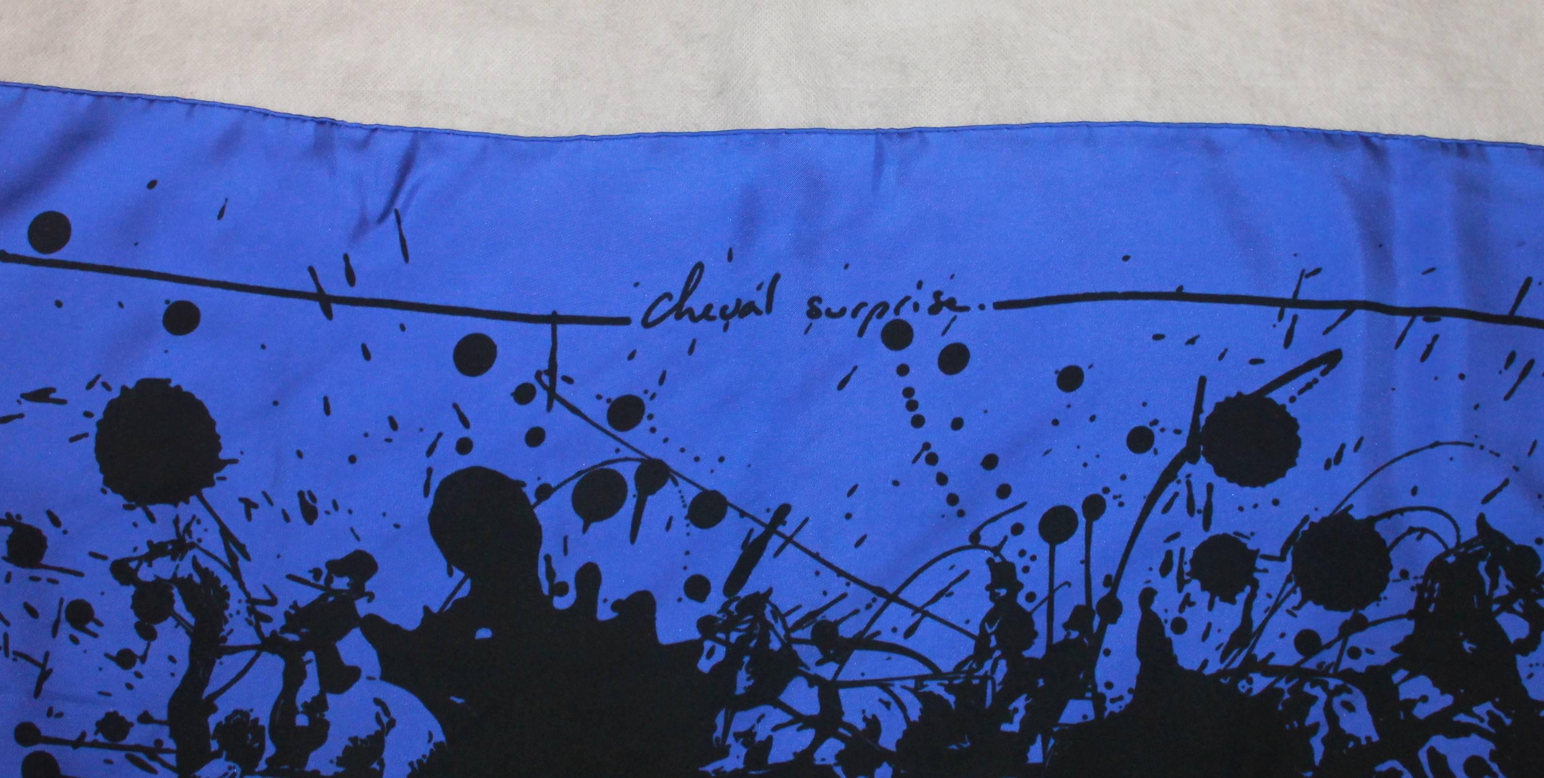 Hermes Large Silk Blue and Black Scarf

This scarf is in excellent condition. It is black and blue and abstract looking with the name 