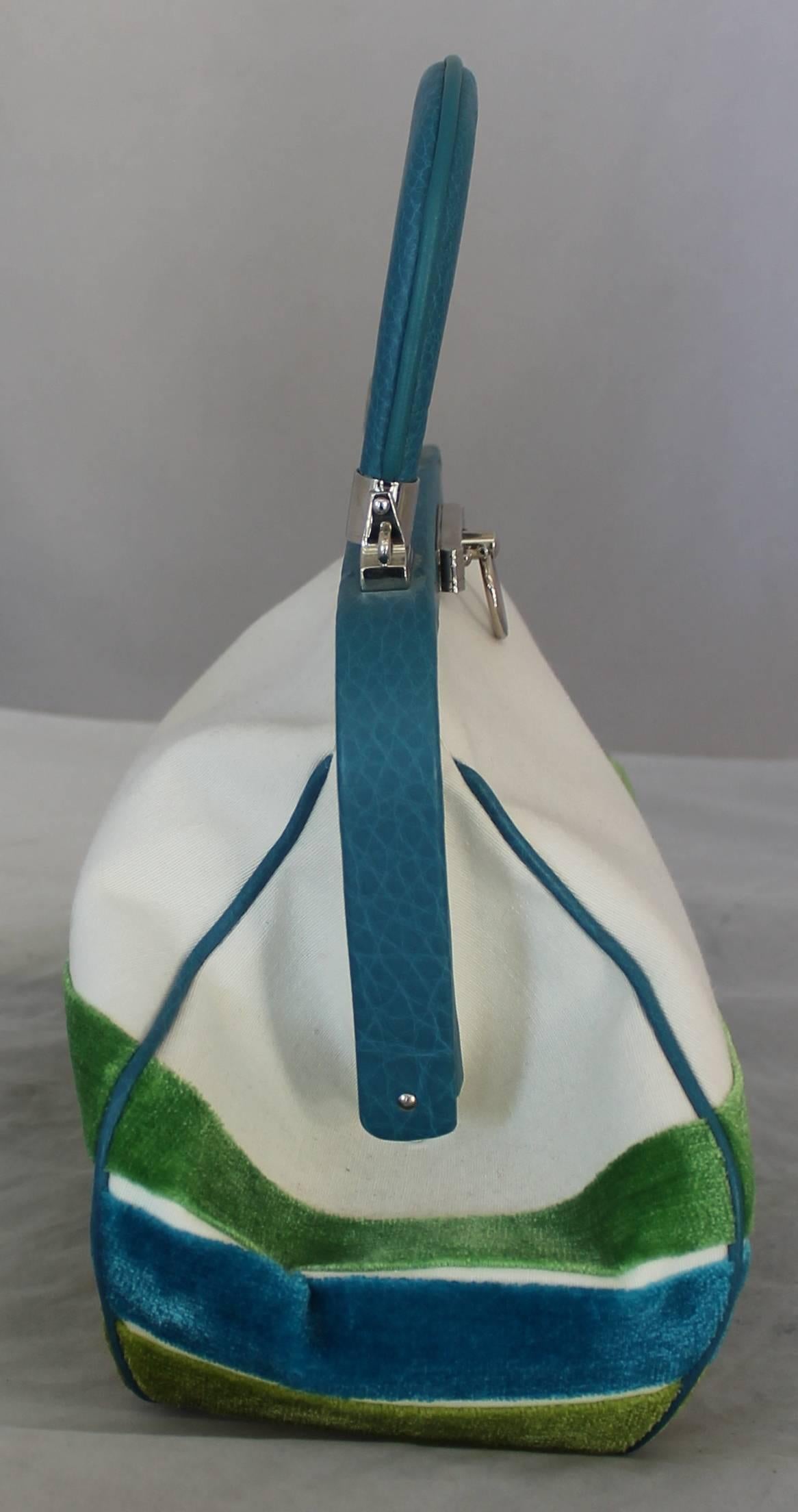 Roberta di Camerino 1990's White, Blue, & Green Velvet & Cotton Handbag.  This vintage bag is in excellent vintage condition.  It features green and blue velvet stripes and a white cotton top.  The trim and the handle are a beautiful blue leather. 