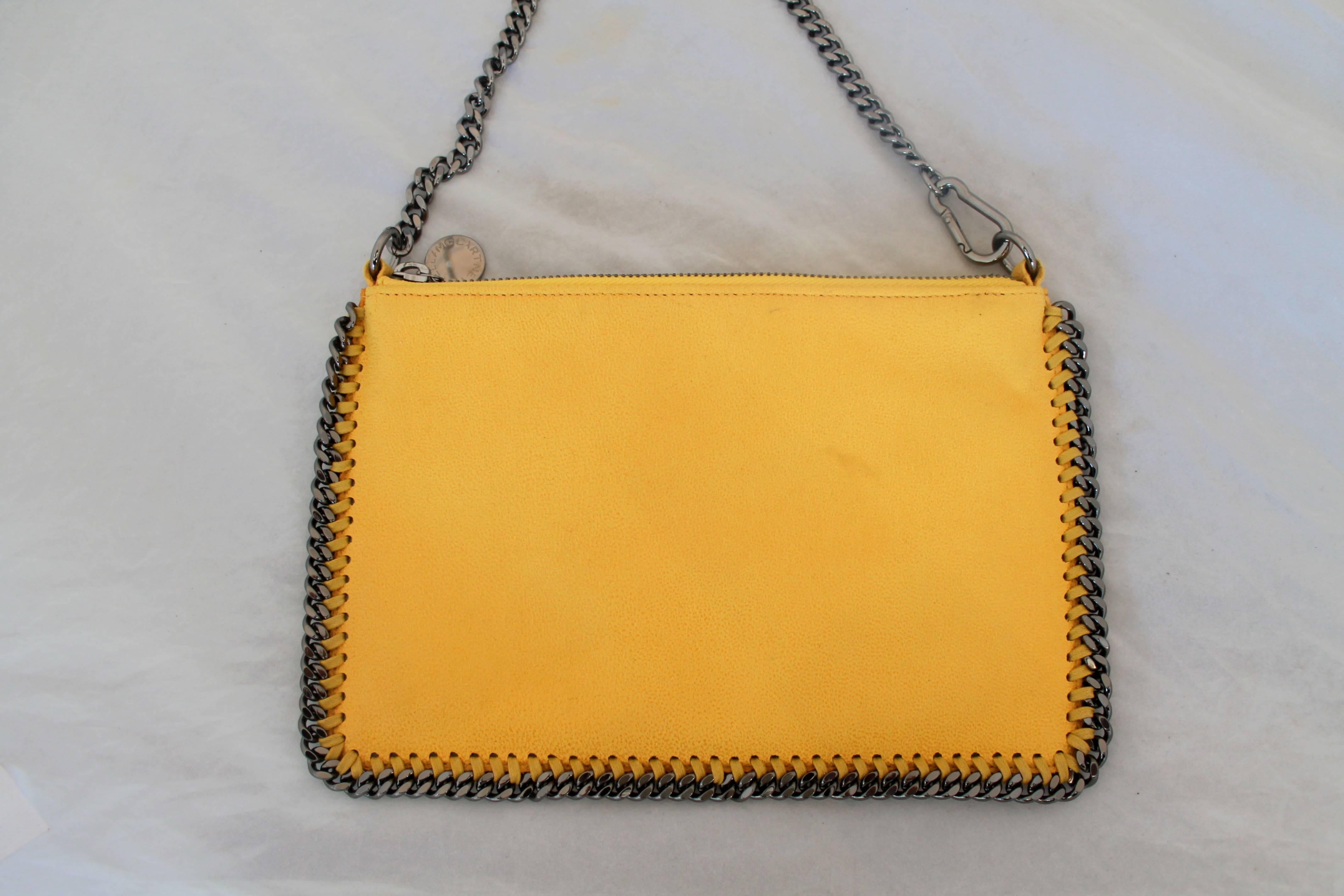Stella McCartney Mustard Pouch w/ Chain Link Trim.  This beautiful bag is in excellent condition.  It features a chain link trim and strap with palladium hardware.  This pouch is vegetarian friendly, using recycled safari