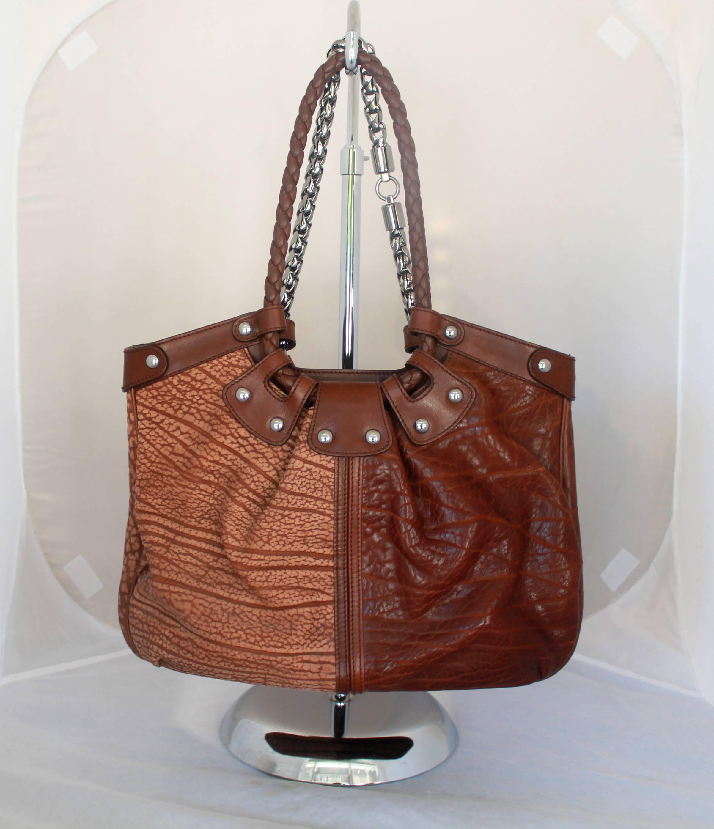 Salvatore Ferragamo Two-Toned Brown Leather Should Bag - SHW

This shoulder bag is in excellent condition. One side of the bag is dark brown and the other is light brown. One strap is braided leather and the other is chain. There are silver studs