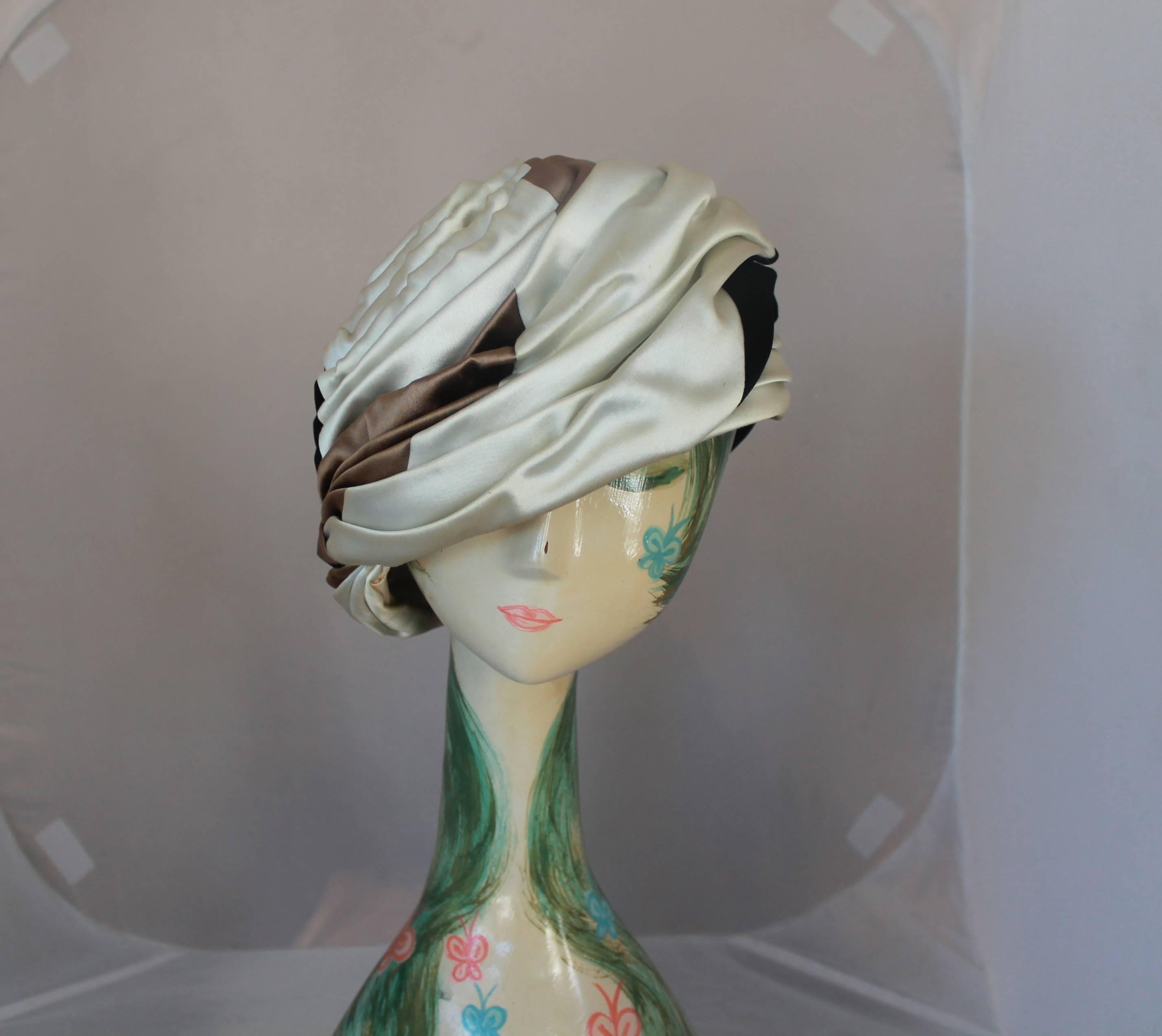 Christian Dior 1960's Vintage Black, Brown & Ivory Silk Turban Hat. This hat is in good vintage condition with some wear on the inside and a minor speck on the top section on the ivory. It is otherwise in great shape and is perfect for collectors.