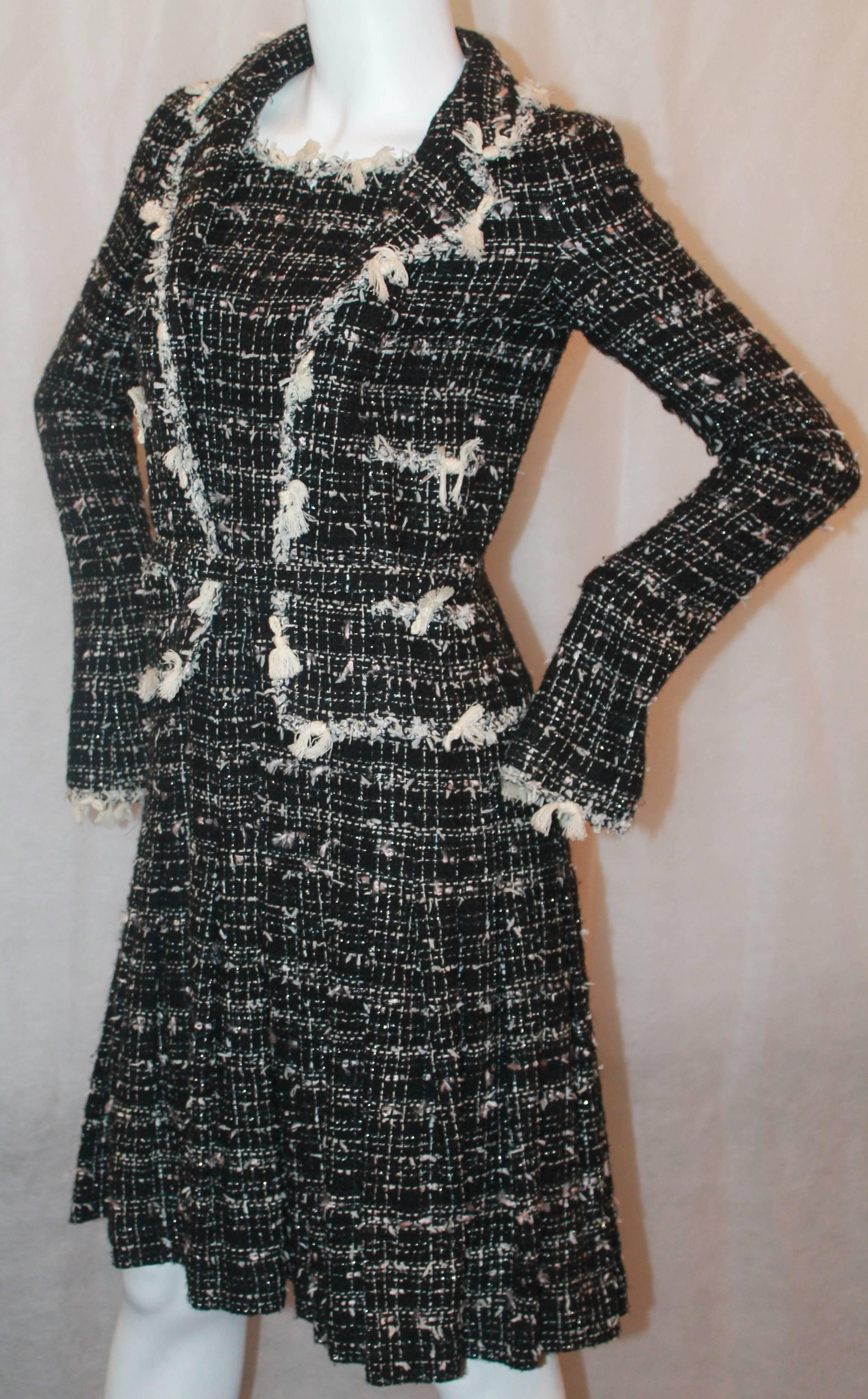 Chanel Black & Ivory Tweed Jacket Style Dress w/ Silver Metallic Stitching - 38 - Circa 05C  This dress gives the illusion that you are wearing a dress with a jacket ensemble. It is in excellent condition.  It features an ivory tassel trim, a