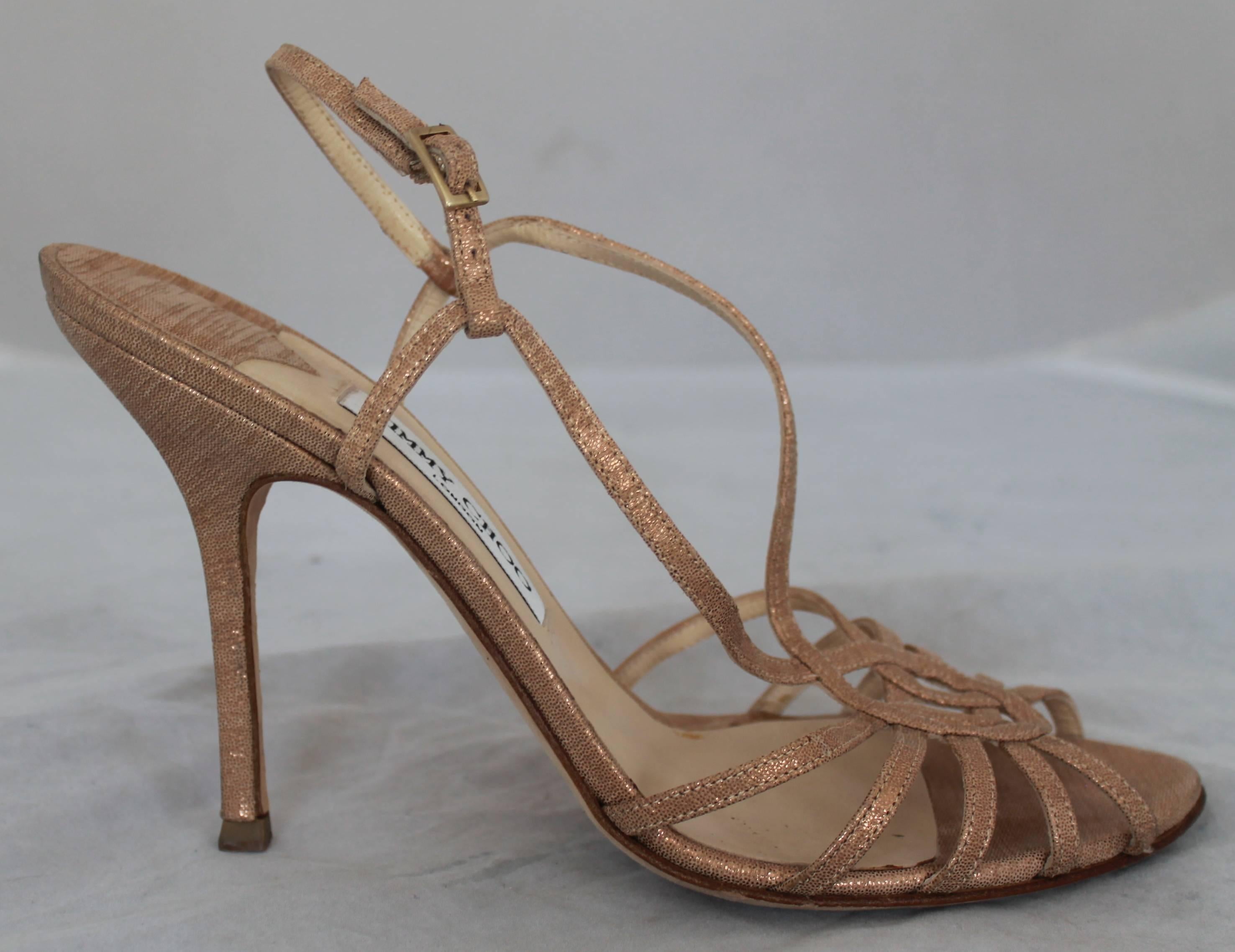 Jimmy Choo Rose Gold Sparkly Slingback Heel  40.5.  These beautifully elegant shoes are in good condition with only some noticeable wear on the sole and on the top of the heel.  They have a lovely strappy toe design.

Measurements:
Heel: 4