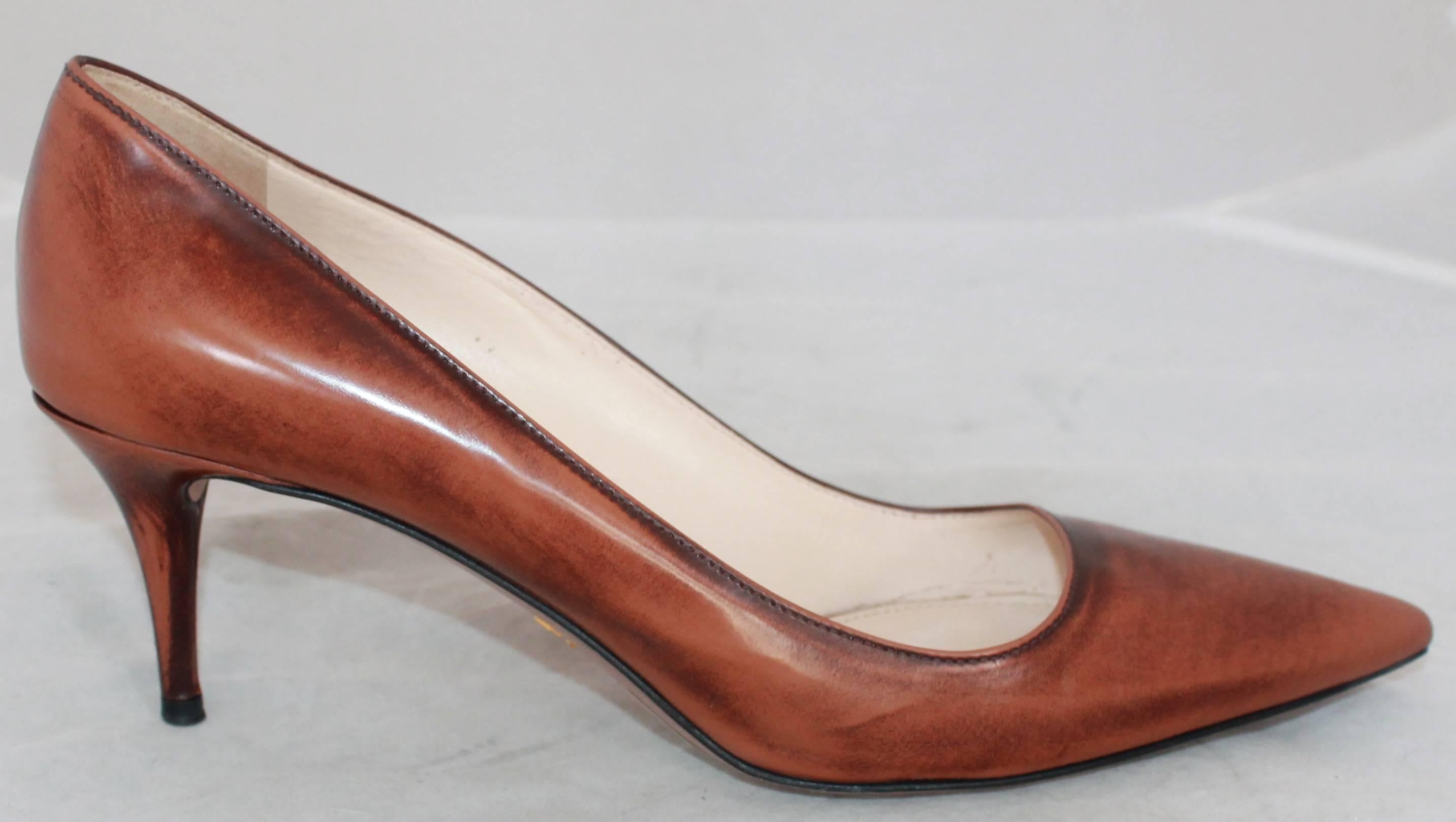 Prada Brown Unfinished Patent Pointed Toe Low Heels - 41.  These shoes are in good condition with noticeable wear on the bottom and slight scuffing on the heel and the points of the toes.  They feature lighter and darker areas on the heels and