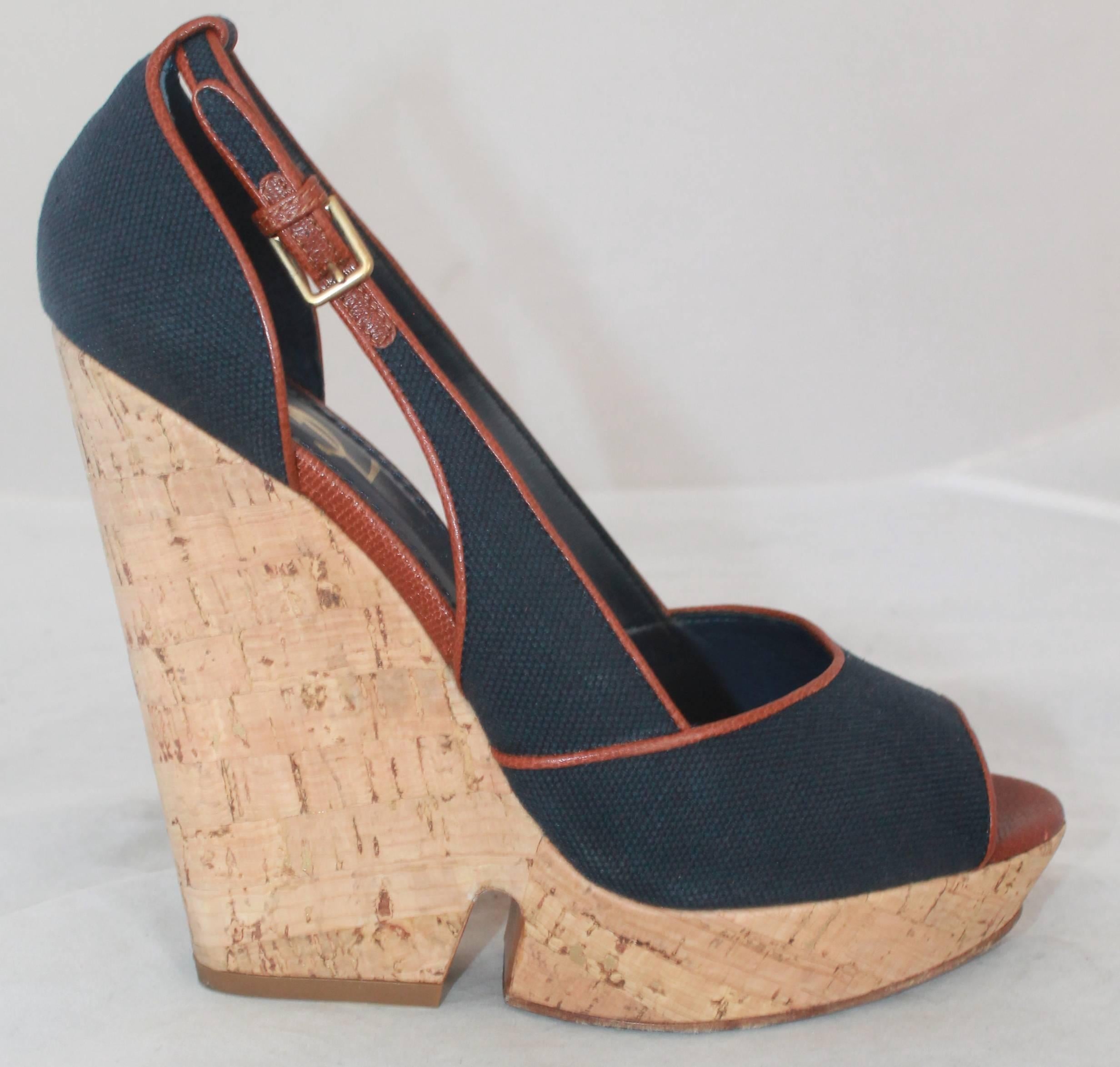 YSL Navy & Brown Deuville Canvas Wedge Sandals - 40.5.  These sandals are in very good condition with only wear visible on the soles.  They feature navy canvas with a brown trim, an open toe, and a cork wedge with gold metallic