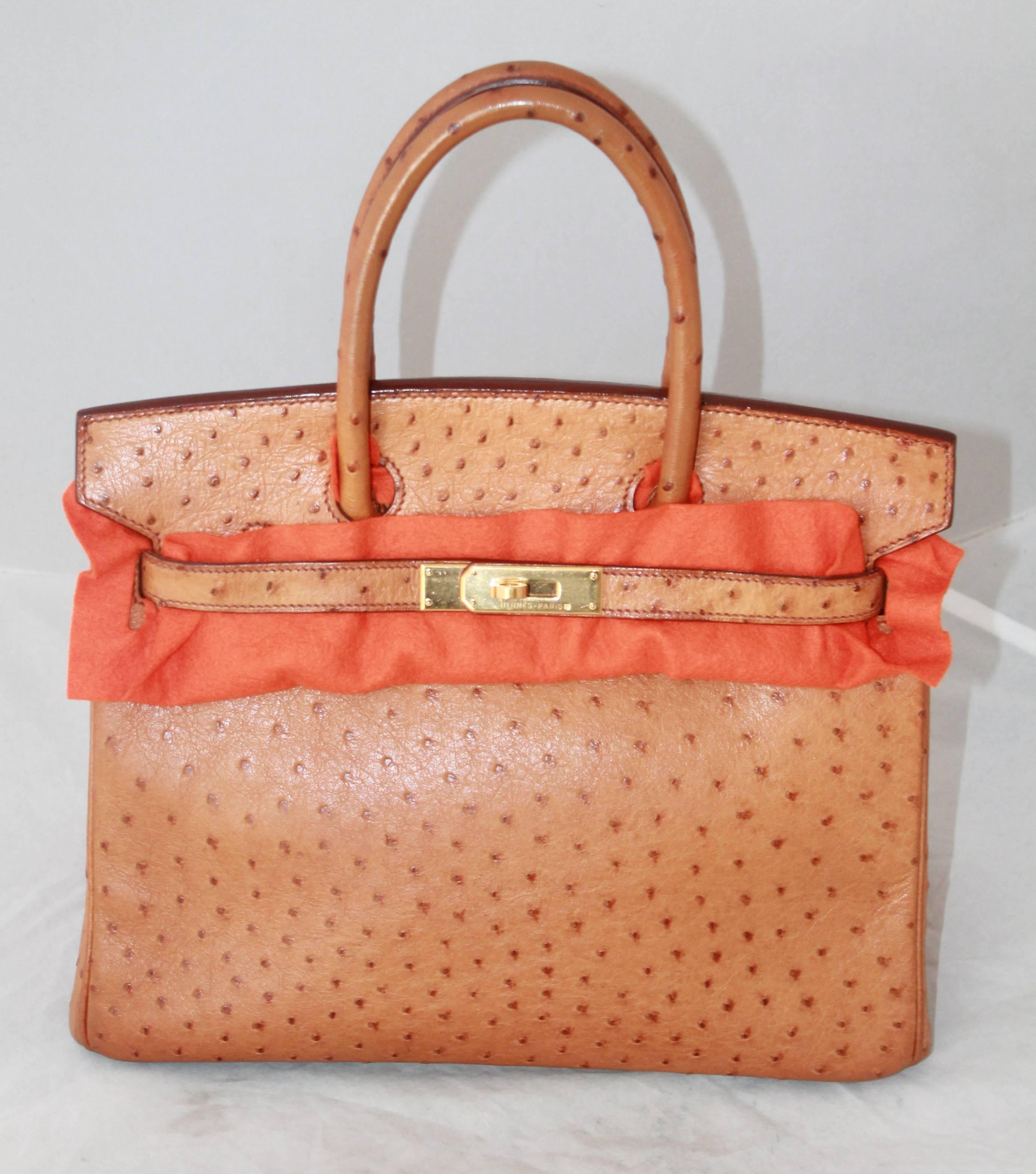 Hermes Gold Ostrich 30cm Birkin Handbag - GHW - 2003. This bag is in excellent condition with minor wear to the hardware. It comes with a duster, the lock, and lock duster. 

Measurements:
Height- 9