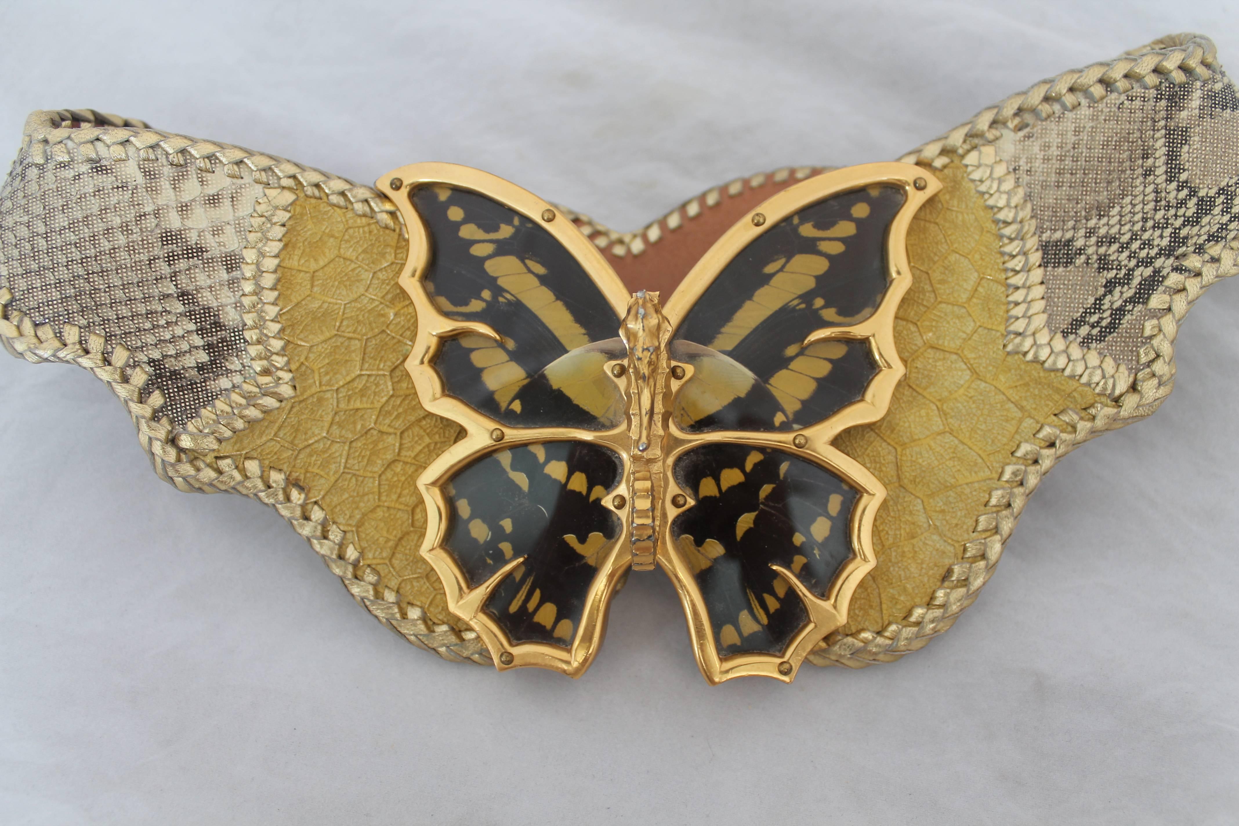 Cesar Ugarte Vintage Gold Python Belt with Brass Butterfly Buckle - cc 1980's. This belt is in excellent condition and is a limited edition piece. It is handmade and is reversible with a matte tan leather inside. The butterfly has a seahorse in the