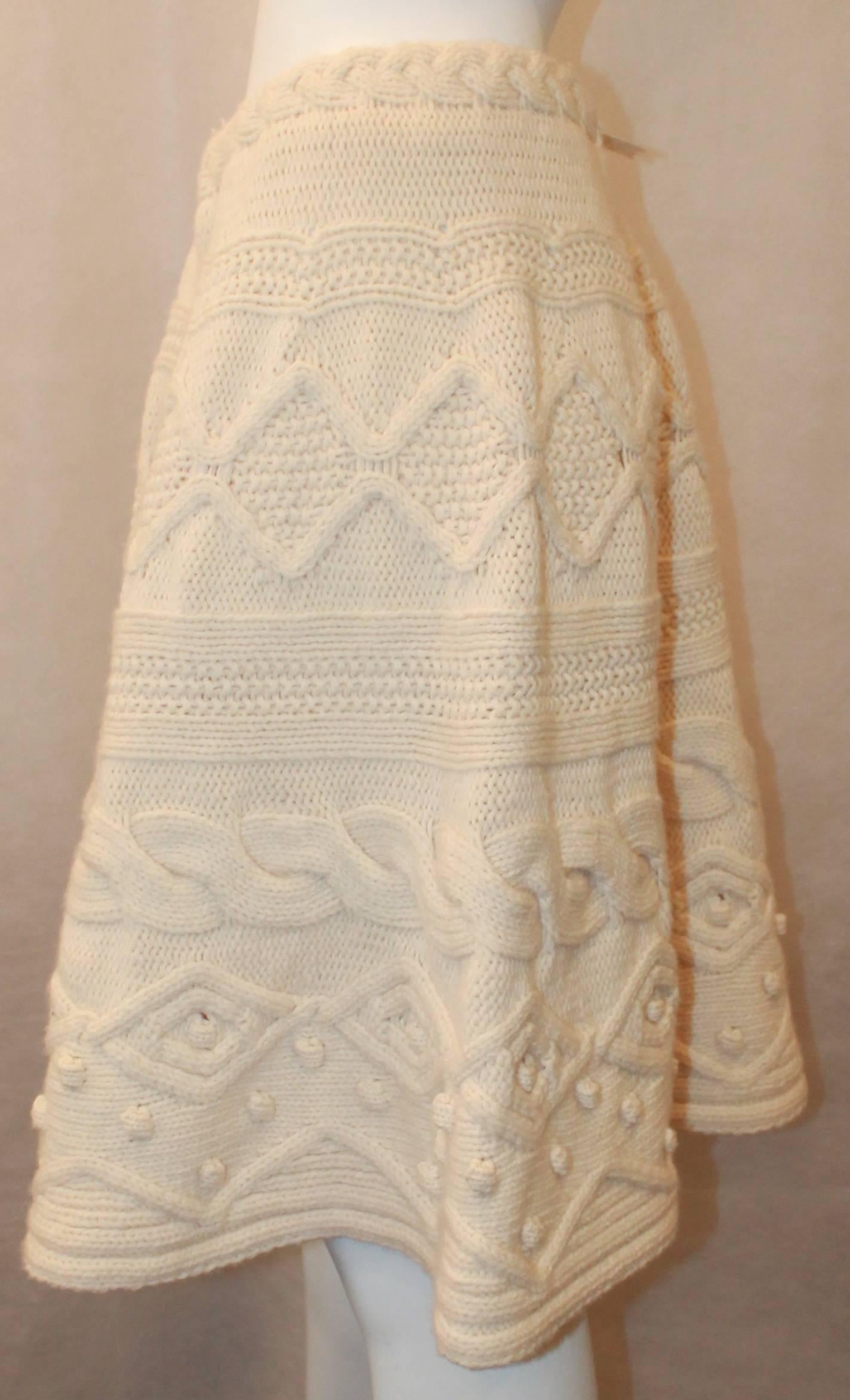 Valentino 1990's Vintage Creme Wool & Cashmere Knitted Skirt - L. This skirt is in excellent vintage condition with very light wear. It is a thick and heavy knit with a patterned design. The skirt has a flowy look and has an elastic