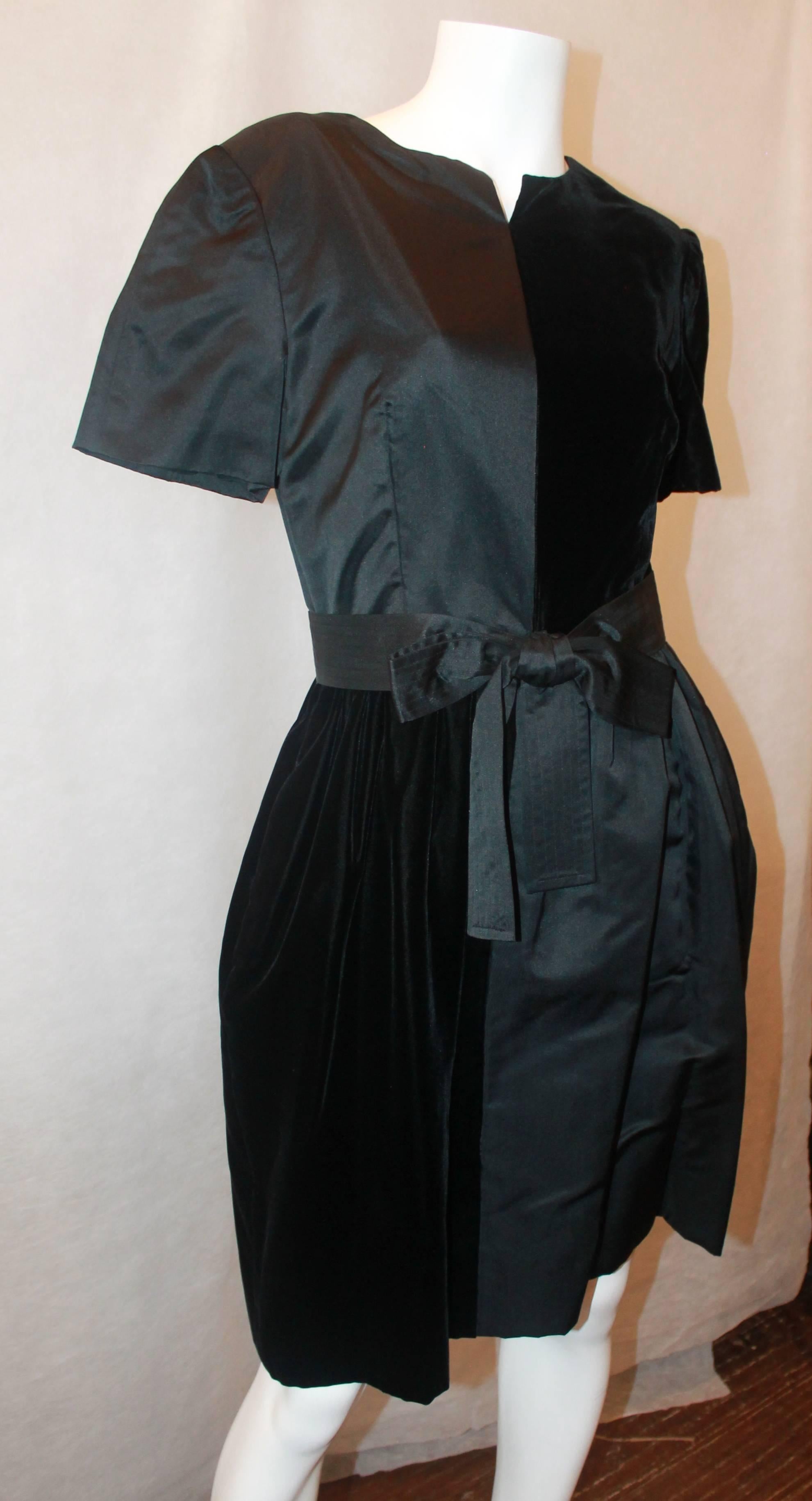 Bills Blass 1970's Vintage Black Velvet & Satin Short Sleeve Dress - 8. This dress is in excellent vintage condition and have a small slit in the front. The dress has 2 side pockets and a larger front bow in satin. The front looks like a large