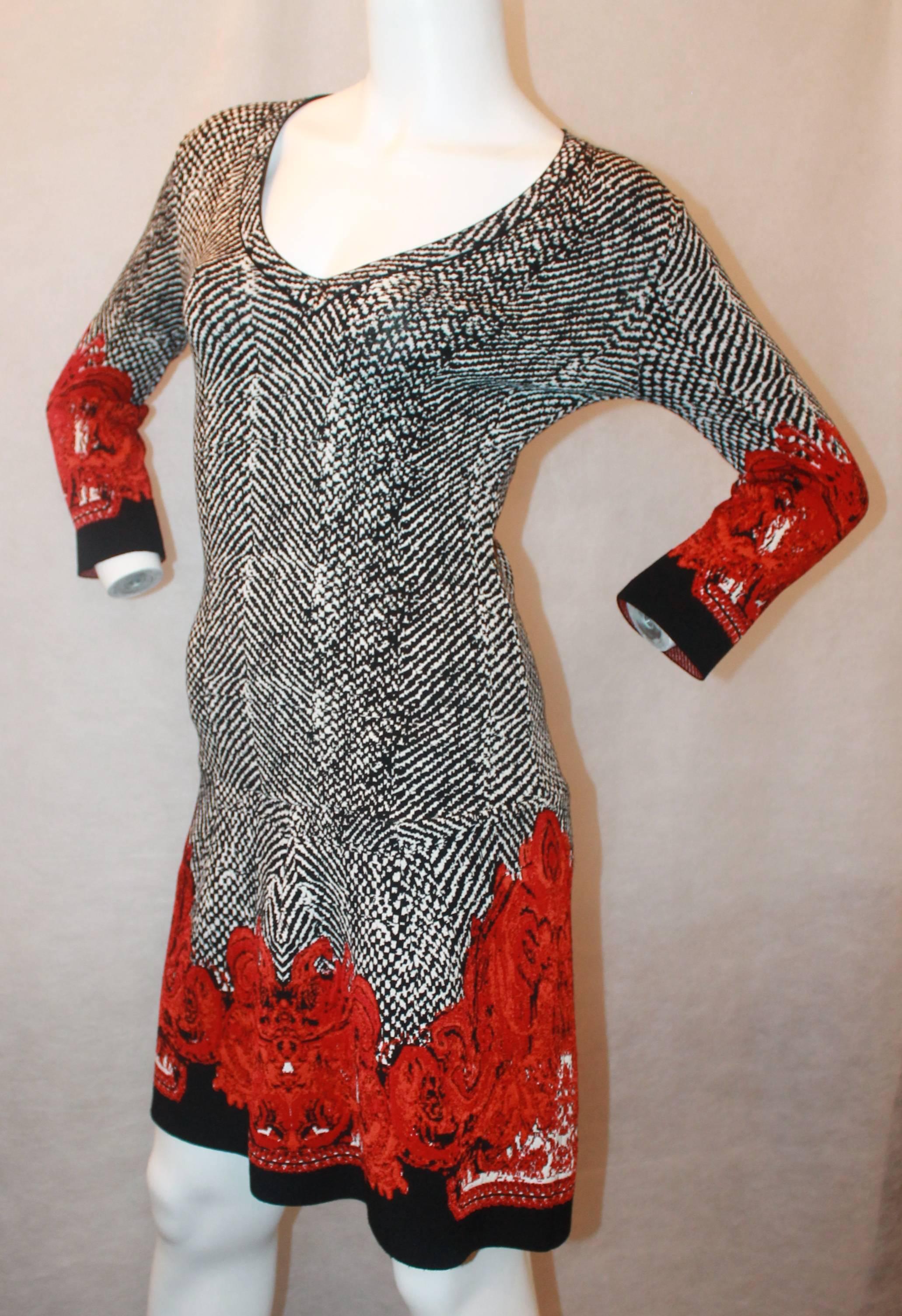 Roberto Cavalli Black, White & Red Printed Long Sleeve Dress - 40. This dress is in excellent condition and has an black & white abstract print all over with a red & red-orange swirl pattern on the bottom & sleeve bottoms. It has a slightly cinched