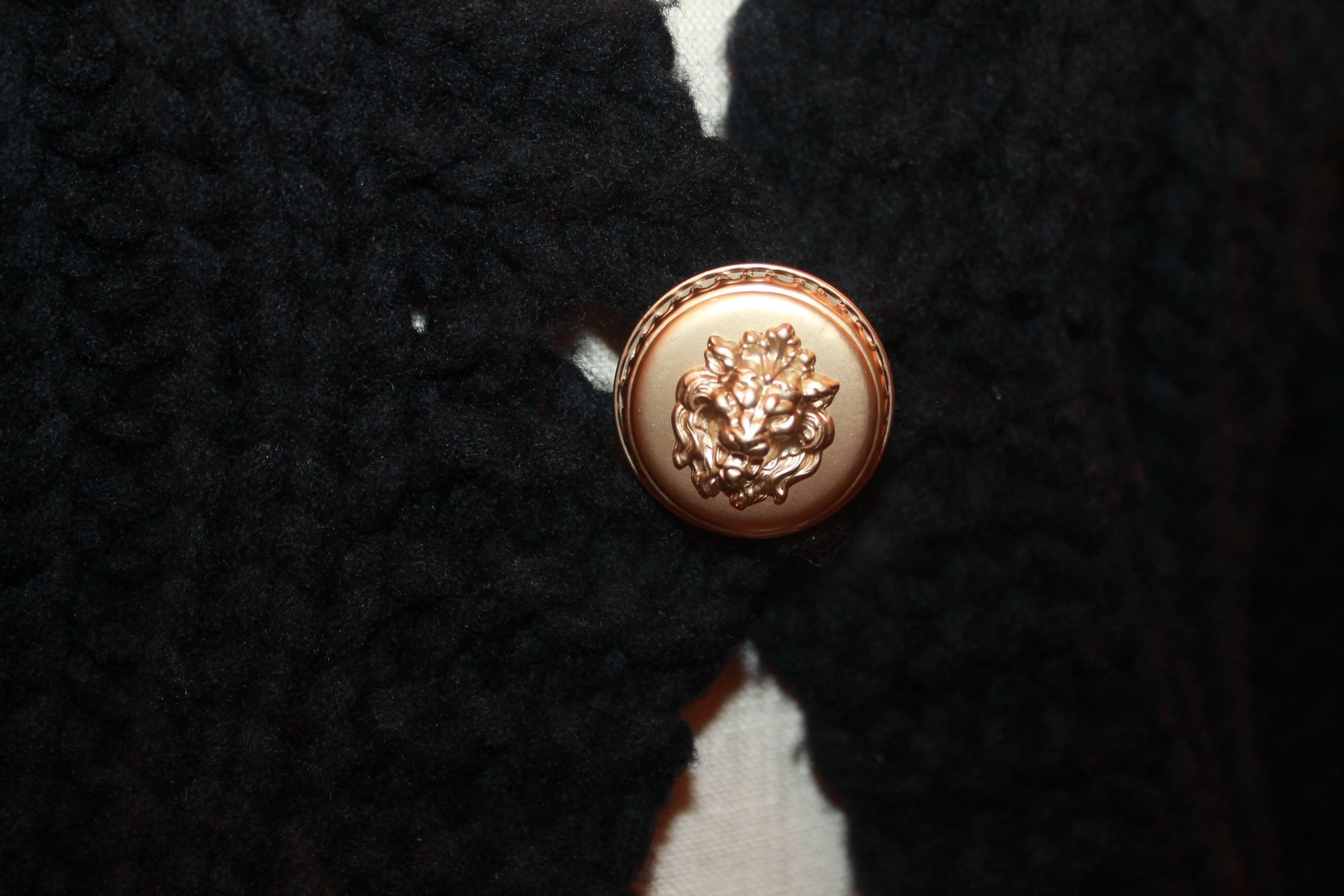 Chanel Black Heavy Knit Sweater w/ Front Gold Lion Button - 42.  This thick Chanel sweater is in good condition with some pilling throughout.  It features a chunk knit, two front pockets, two large gold lion buttons on the front and the back, and a
