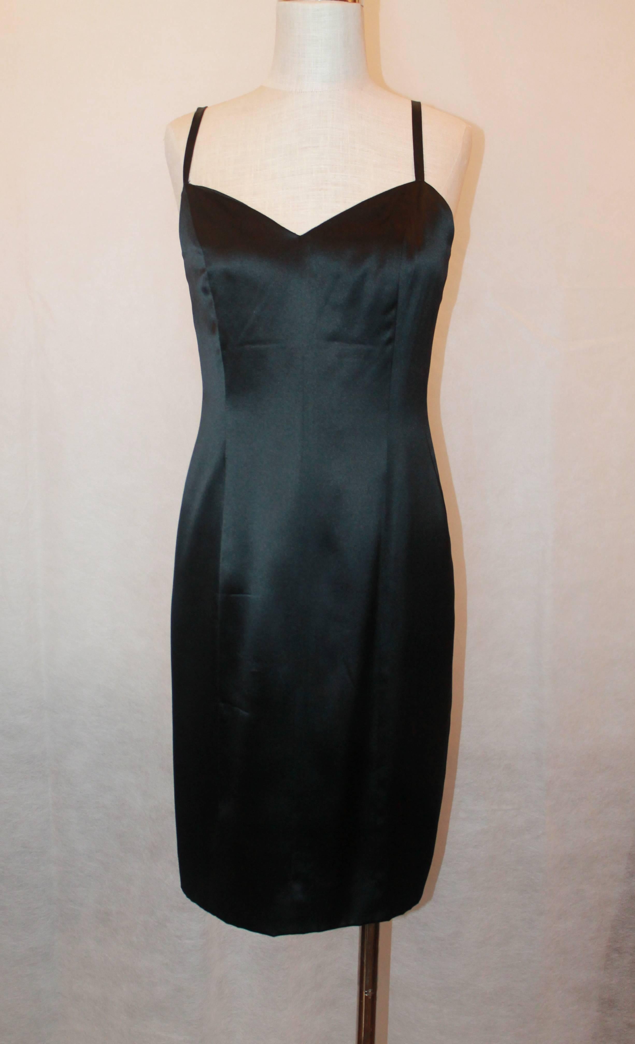 Chanel Black Fitted Silk Slip Dress w/ Spaghetti Straps - 44 - 1995.  This beautiful Chanel dress is in excellent condition.  It features gorgeous black silk, a stunning figure flattering shape, and spaghetti straps.  It was a perfect little black