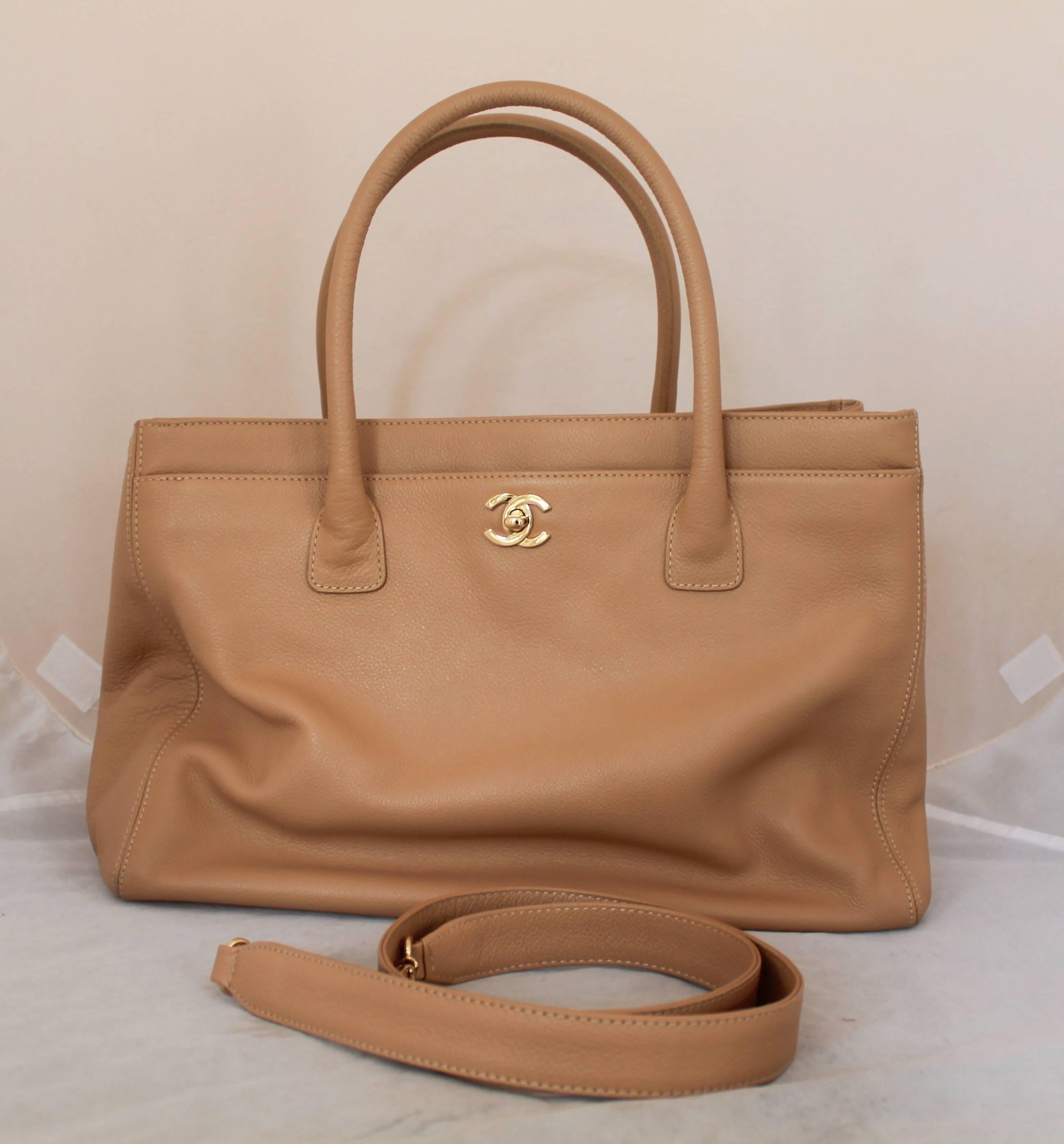 Chanel Nude Caviar Leather Cerf Tote - GHW - 2004. This beautiful tote has two top handles and three different sections. The first section closes with a gold turnkey lock and has a gold Chanel logo on the front. The middle section closes with 2