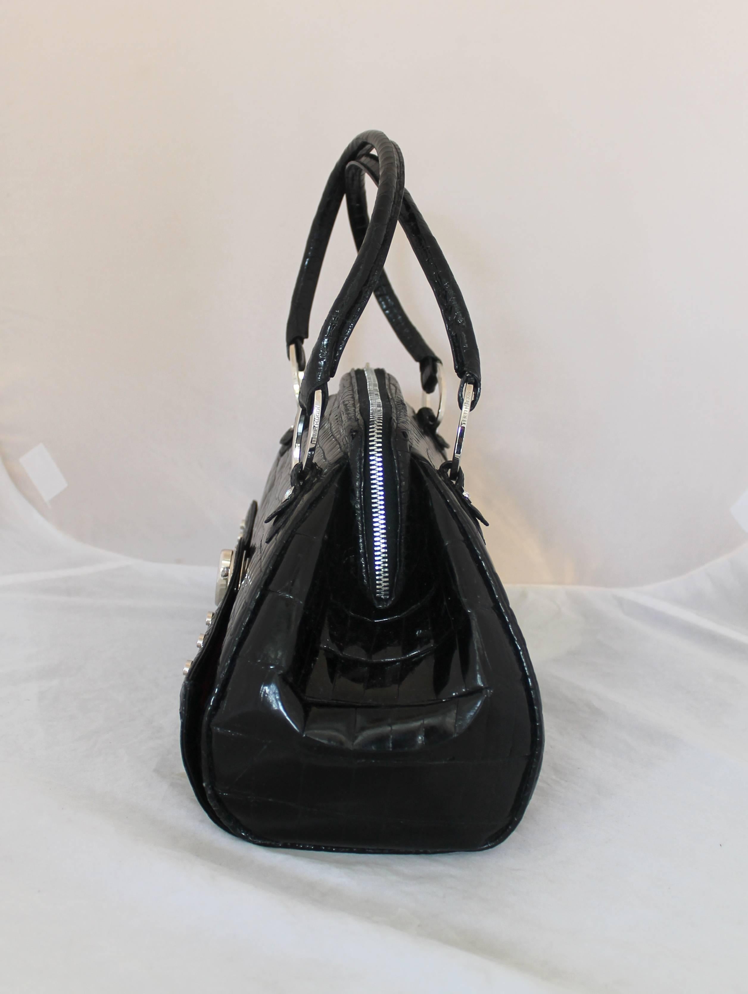Judith Leiber Black Crocodile Shoulder Bag

This bag is in excellent condition with minor water marks on it. It has silver hardware and small silver studs in the front of the bag. The zipper clasp also has rhinestones on the edge of it. It has a