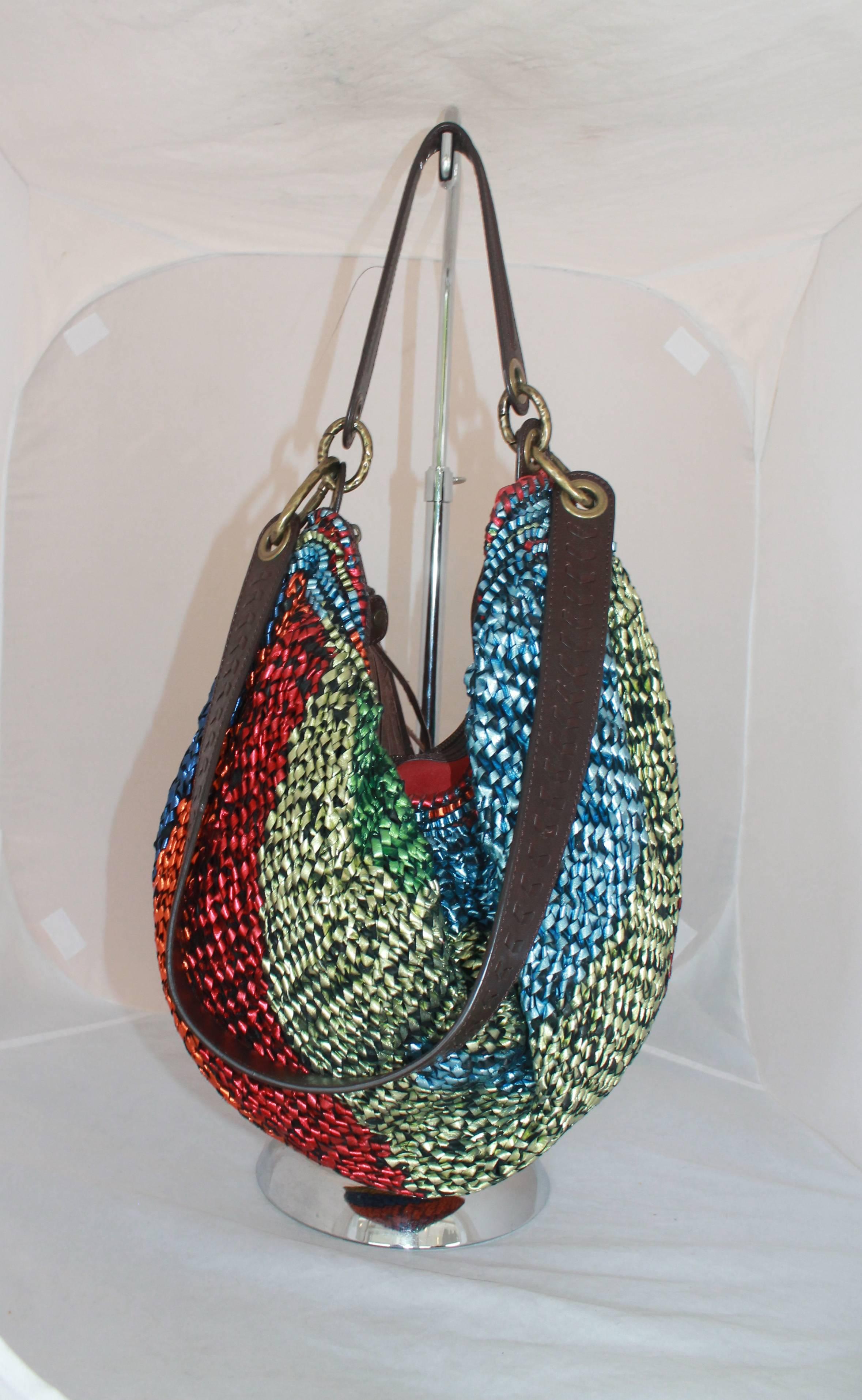 Diane von Furstenburg Woven Multicolor Metallic Leather Hobo Shoulder Bag

This bag is in excellent condition. It has reds, blues, greens, and yellows with a brown leather handle and a fringed tassel. 

Measurements:

Height - 12