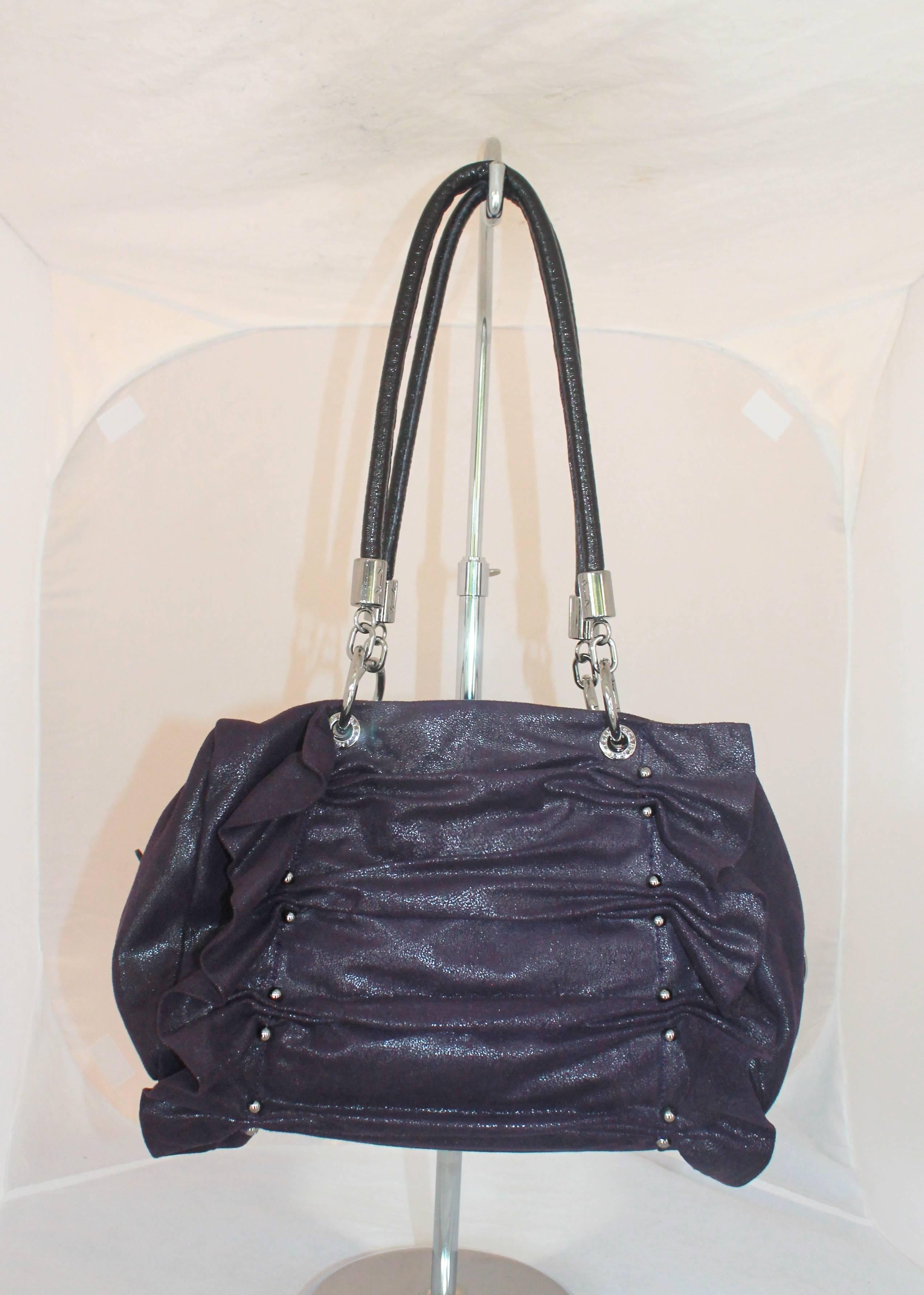 Stella McCartney Deep Purple Cracked Suede Ruched Shoulder Bag

This bag is in excellent condition. It has silver hardware with front and back ruching. It has silver studs and the bags fabric has a slight sheer look to it. Also comes with a coin