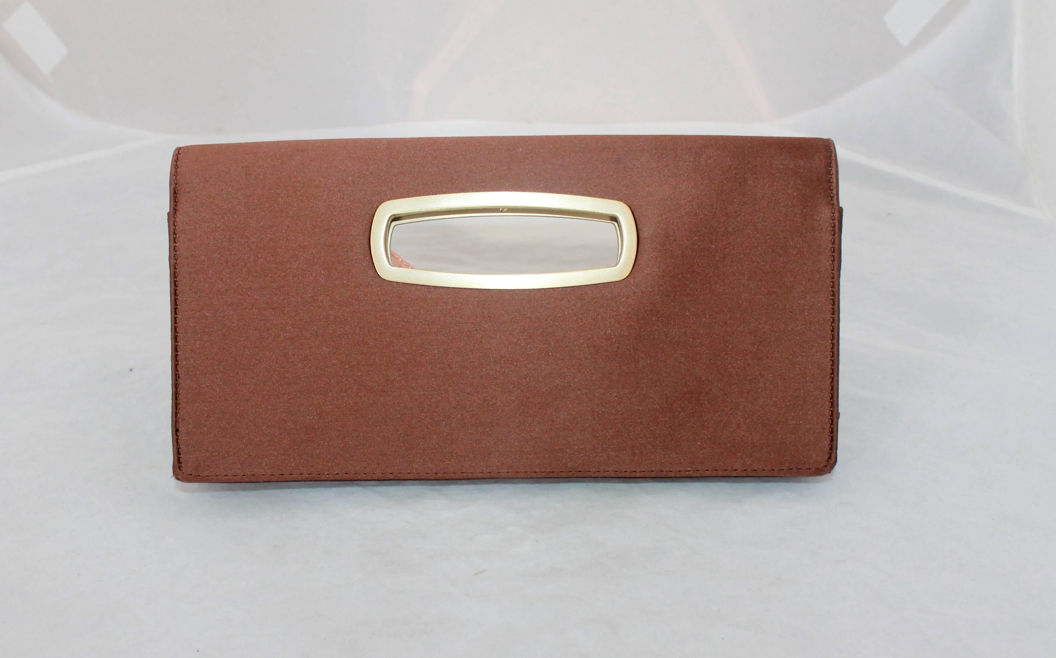 Jimmy Choo Brown Satin Clutch with Gold Cutout Handle. This clutch is in very good condition with minor areas wear on both sides. It is a foldover clutch and has a magnetic clasp. The gold cutout has the Jimmy Choo logo in the center on the