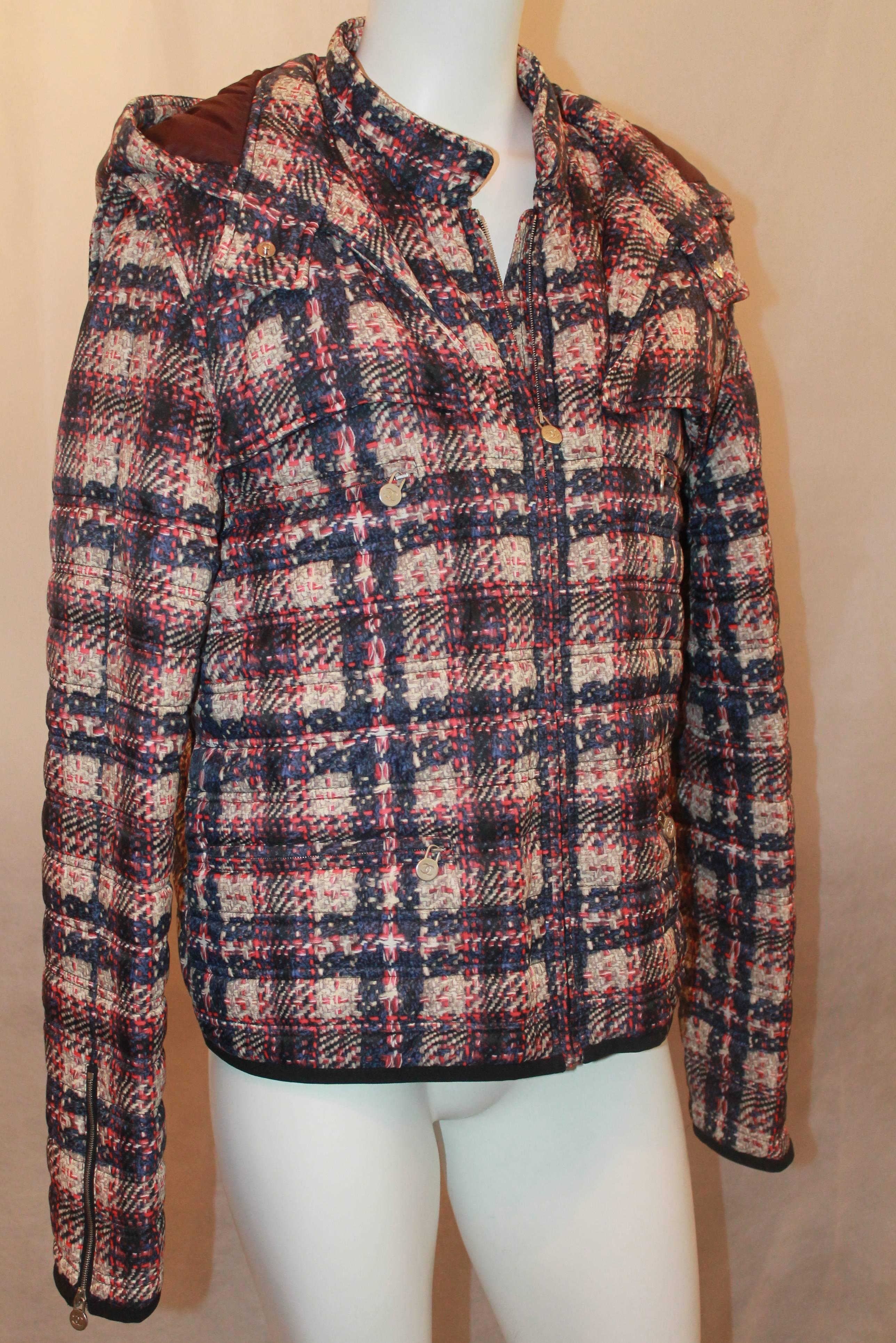 Chanel multi plaid puffer jacket w/ removable hood - Sz 46 - NWT - Circa 2013 The plaid on the jacket is a combination of pink, purples and ivory. It has a detachable hood, front zip and 2 front zipper pockets. Also zips on the ends of the cuff. NWT