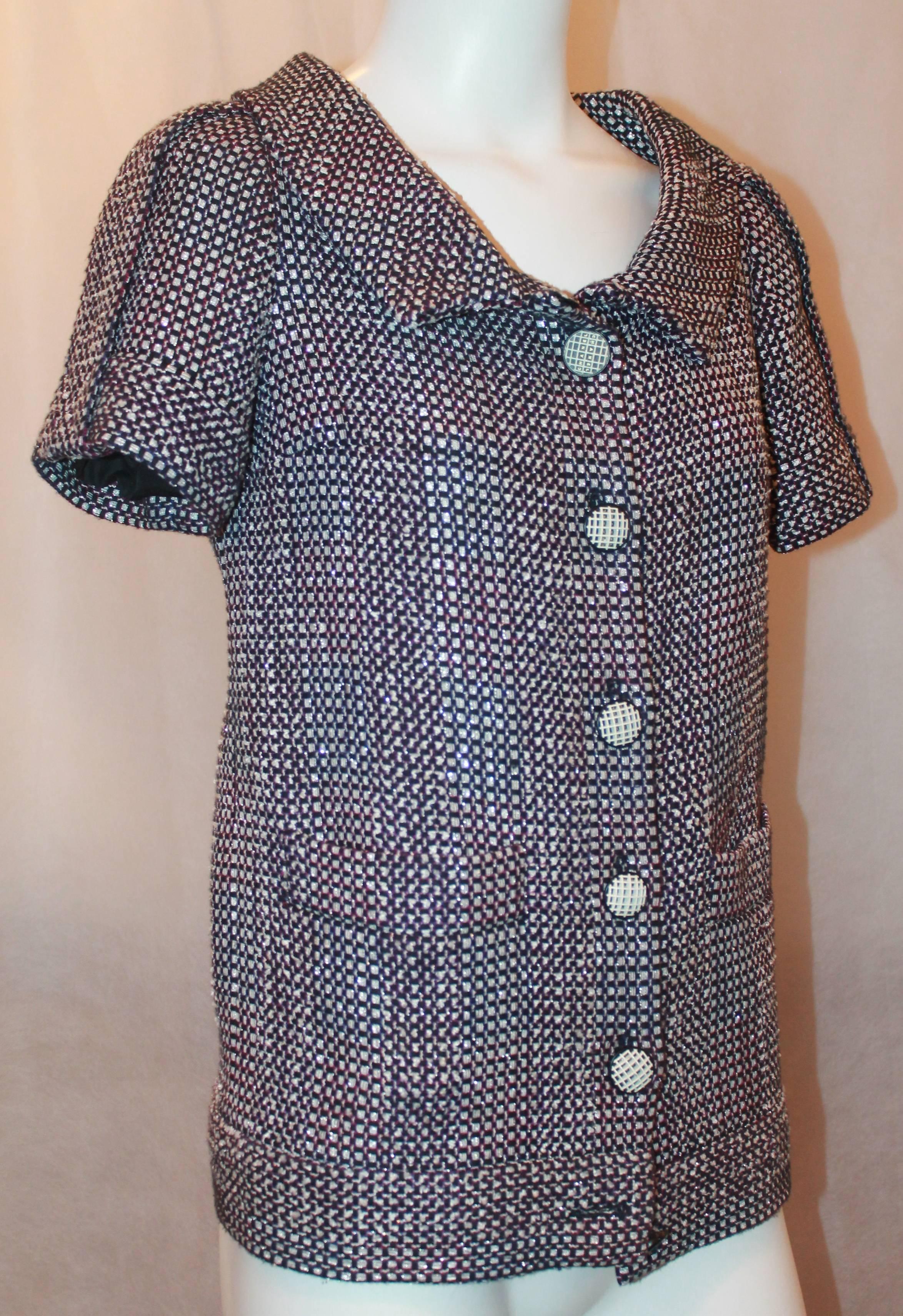 Chanel Navy, White, Pink, & Purple Tweed Short Sleeve Jacket - 34.  This lovely Chanel Jacket is in excellent condition.  It features a collar, two front pockets, black and white buttons with Chanel inscription, and a black 
