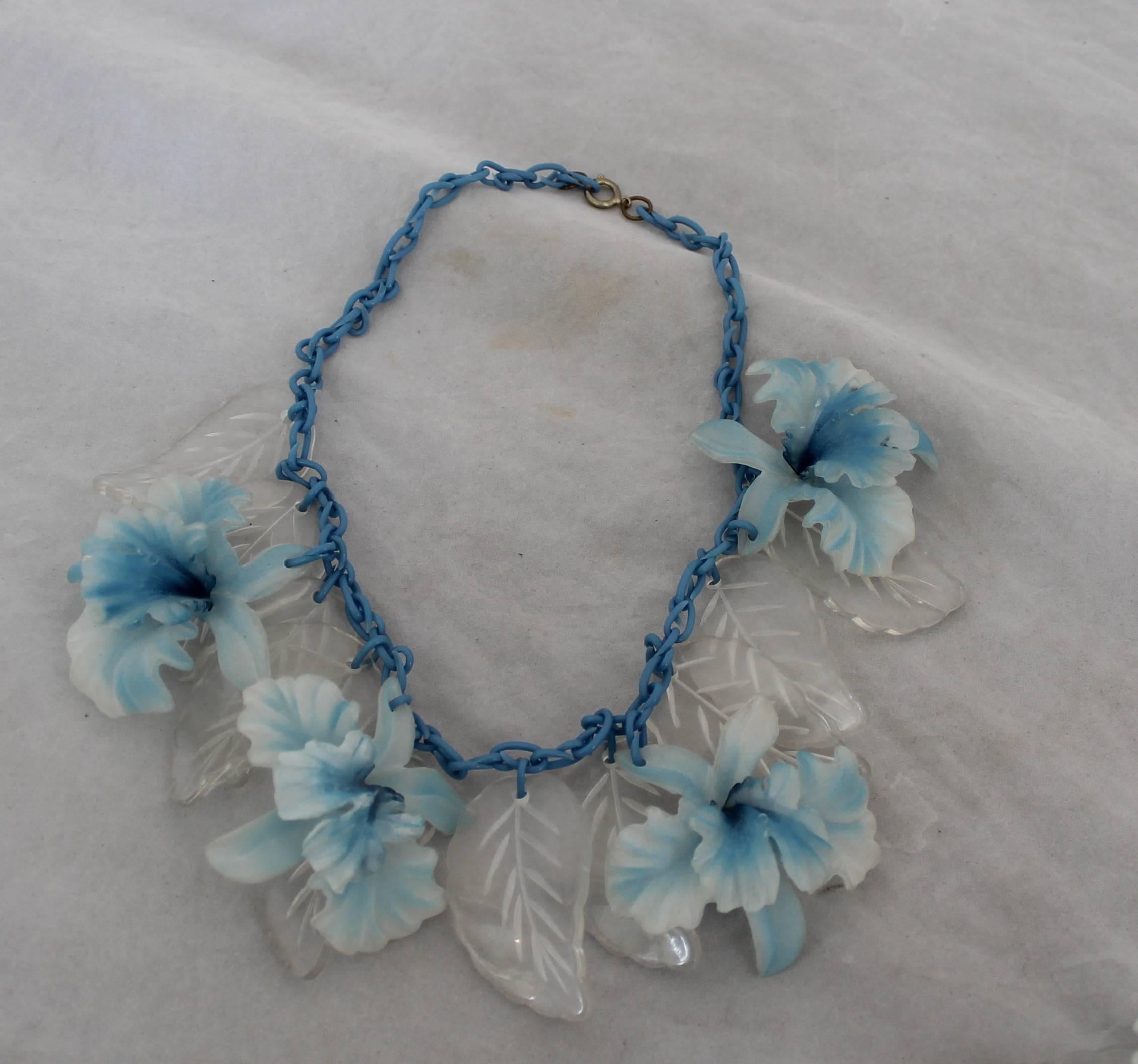 Vintage Blue Celluloid & Reverse Carved Lucite Demi Parure.  This fun set of necklace and earrings is in good vintage condition with some wear consistent with age.  It features a blue celluloid and reverse carved Lucite.

Measurements:
Necklace