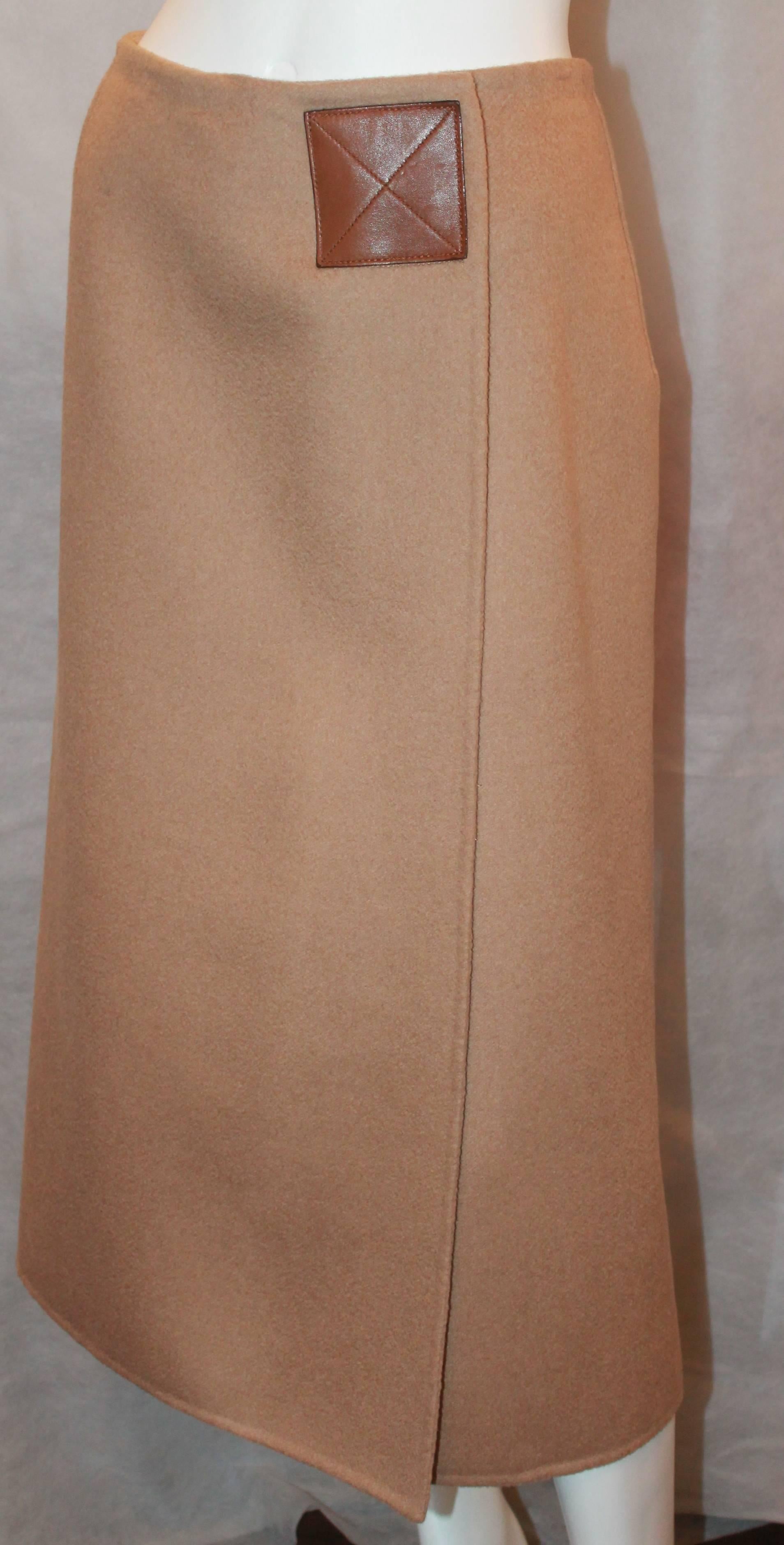 Michael Kors Camel Hair Wrap Skirt - 8 - 1990's.  This simple, but lovely skirt is in excellent condition.  It features a leather Velcro patch and inside button for securing the wrap skirt.  It is a longer midi length.

Measurements:
Waist: