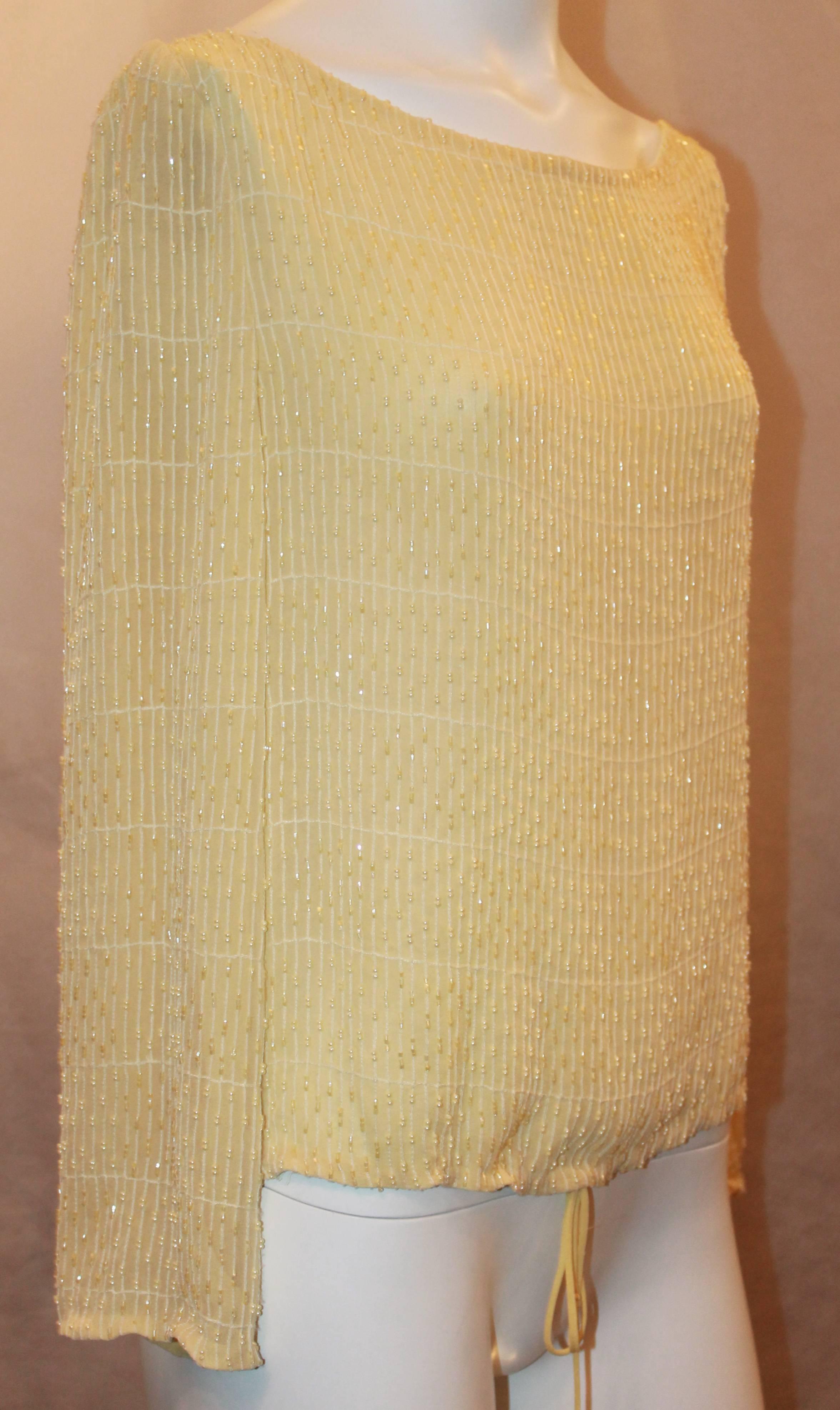 Badgley Mischka Pale Yellow Silk Chiffon Long Sleeve Top w/ Beading - 4.  This lovely top is in good condition with only some wear.  It features a beautiful silk chiffon material, pearls and beads, and a cinched bottom and sleeves.  It is a peasant