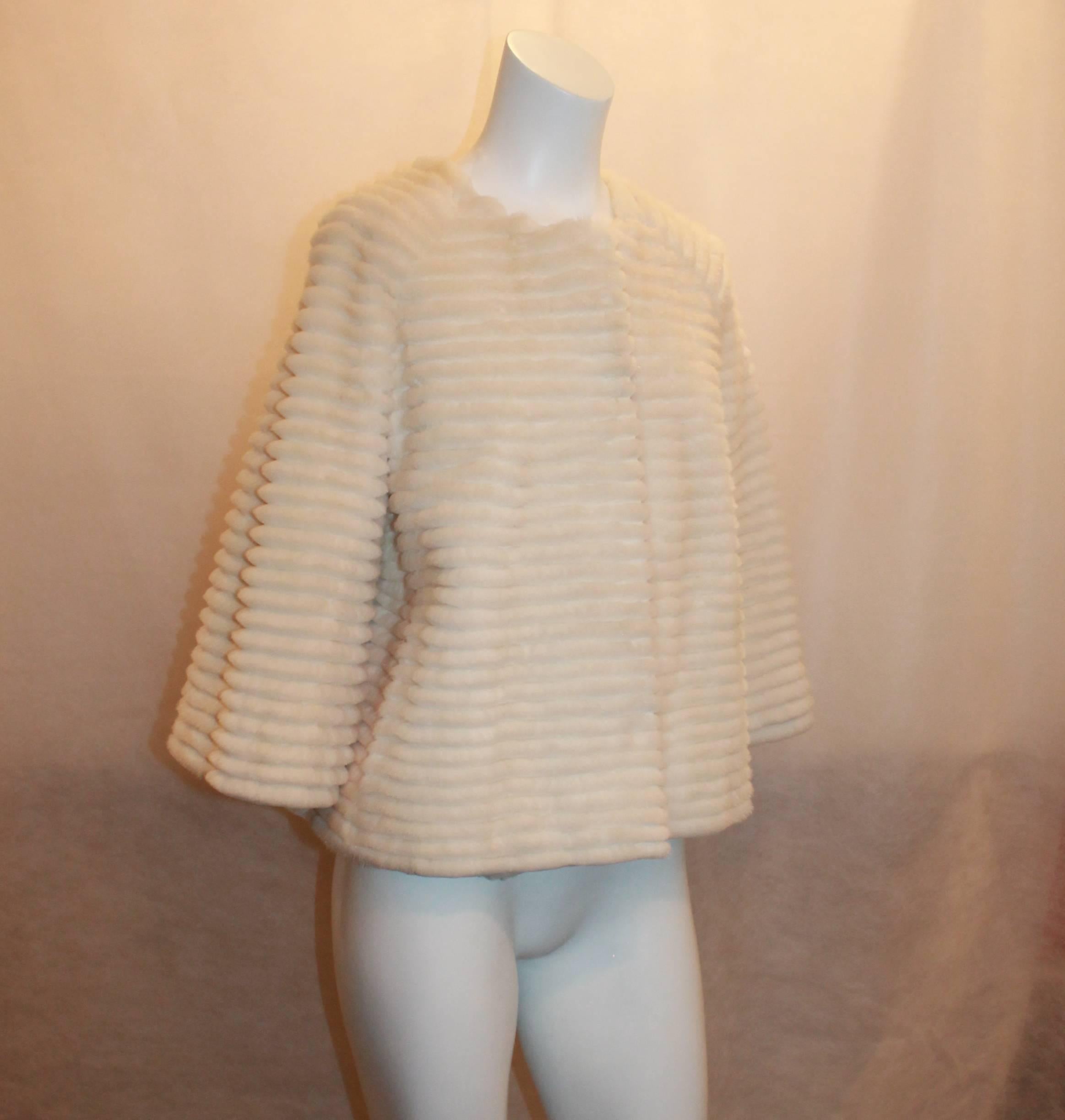 Bisang Ribbed Ivory Mink Swing Jacket - 8.  This beautiful jacket is in excellent condition.  It features 3/4 length sleeves, four hook closures, two pockets, silk lining, and a beautiful mink fur.

Measurements:
Shoulder to Shoulder: