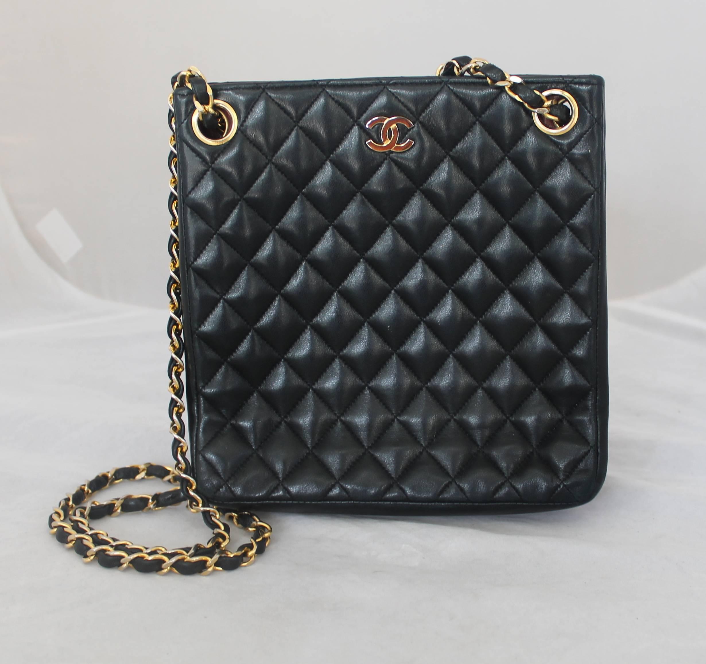 Chanel Vintage Black Quilted Lambskin Tall Handbag GHW - circa early 1980's.  This gorgeous Chanel bag is in excellent vintage condition.  It features a lovely black quilted lambskin, gold hardware, a long signature woven Chanel strap, and a unique