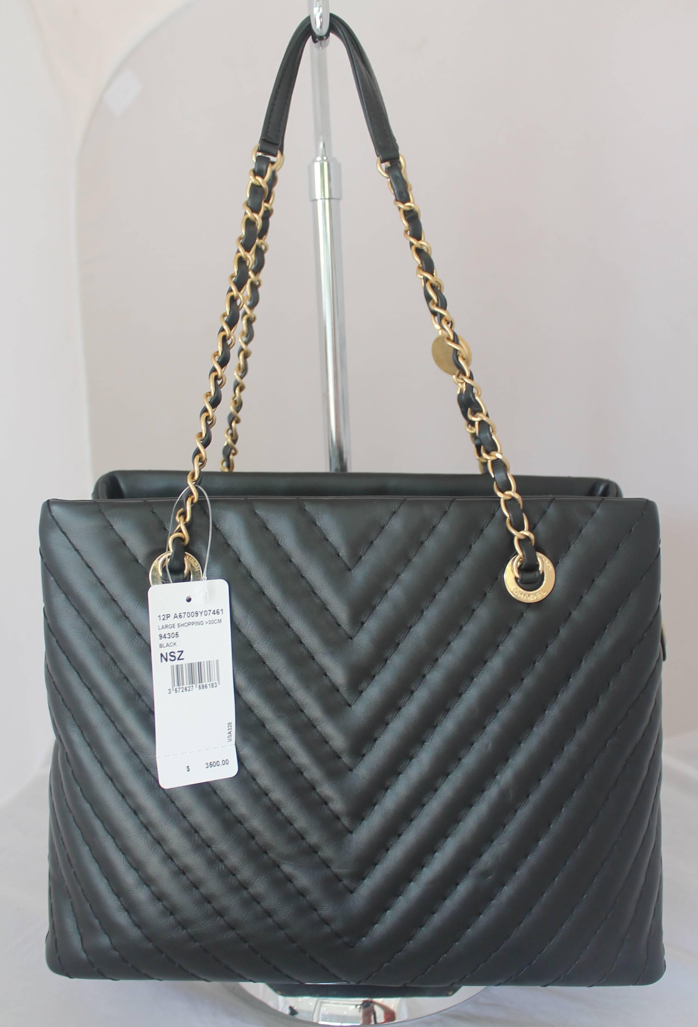 Chanel Black Leather Chevron Shopper Tote - circa 2013-2014. This bag is brand new with tags still attached and has never been worn. It has a matte gold hardware and the inside has 3 compartments with the center one having a