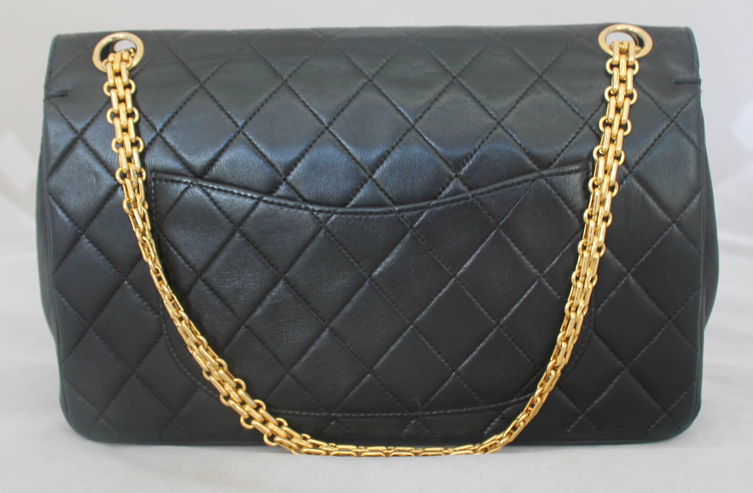 Chanel Black Quilted Lambskin Classic Double Flap Handbag - GHW - Circa Early 1980's.  This beautiful vintage Chanel bag is in very good vintage condition with only a minor scratch on the second flap.  It features the classic black quilted lambskin,