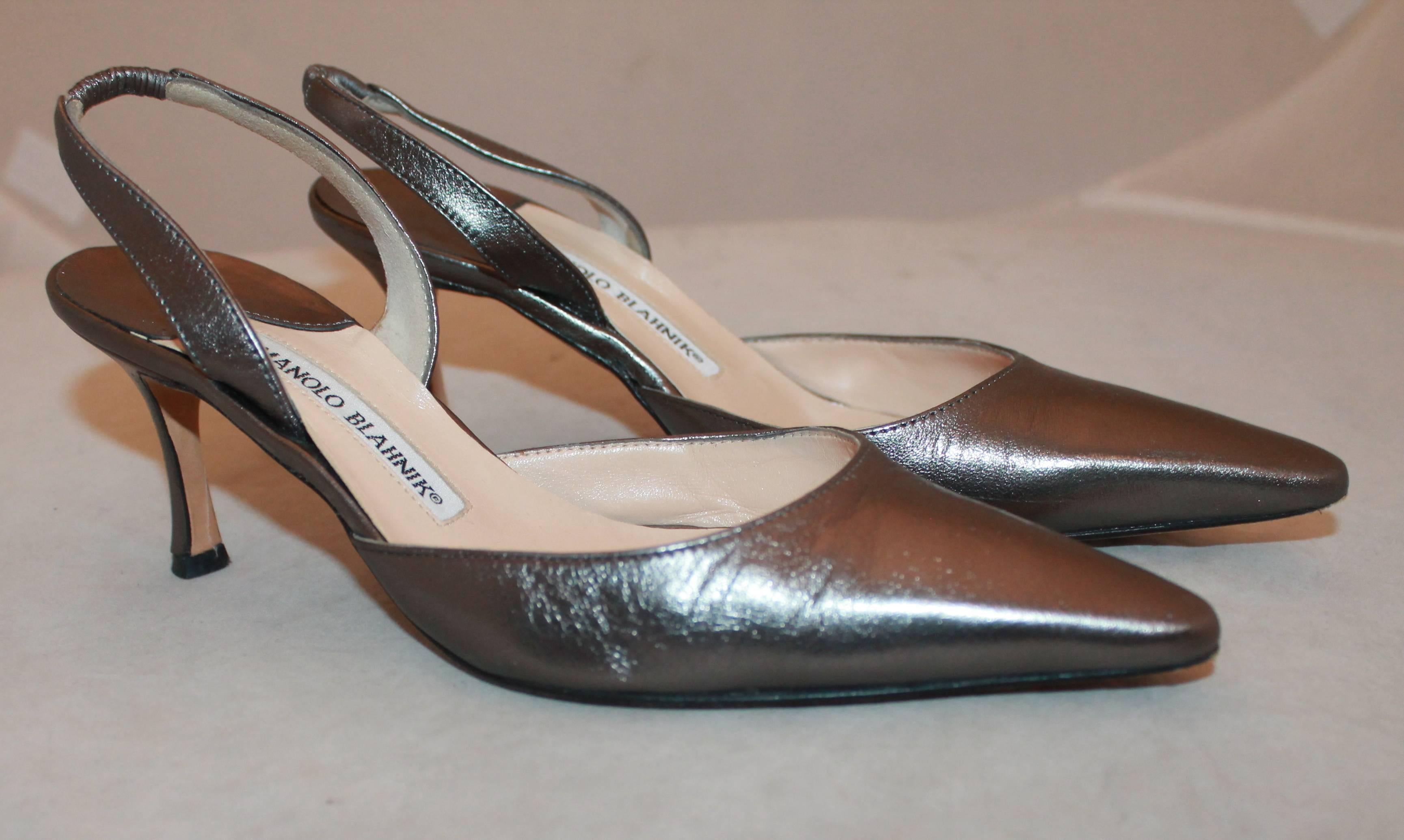 Manolo Blahnik Caroline Gunmetal Heels - 35.5.  These lovely shoes are in very good condition with only some wear consistent with their age.  They feature an edgy gunmetal look, with a classy pointed toe, a slingback strap, and a shorter