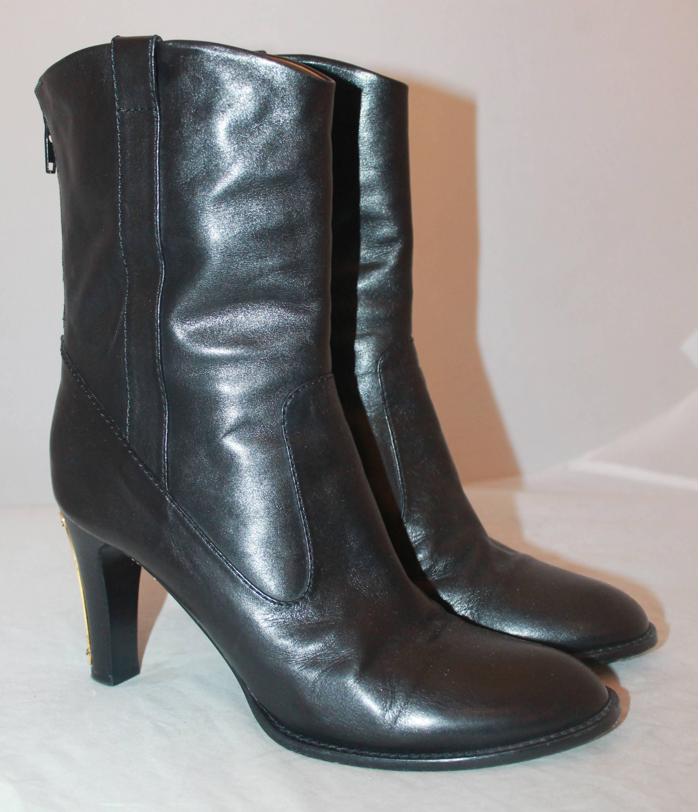 Chloe Black Leather Boots with Gold Detail - 38.5. These beautiful boots are the perfect piece for the cold seasons. They have a sleek design with a back zipper and gold detail on the back of the heels. The boots are in good condition with some
