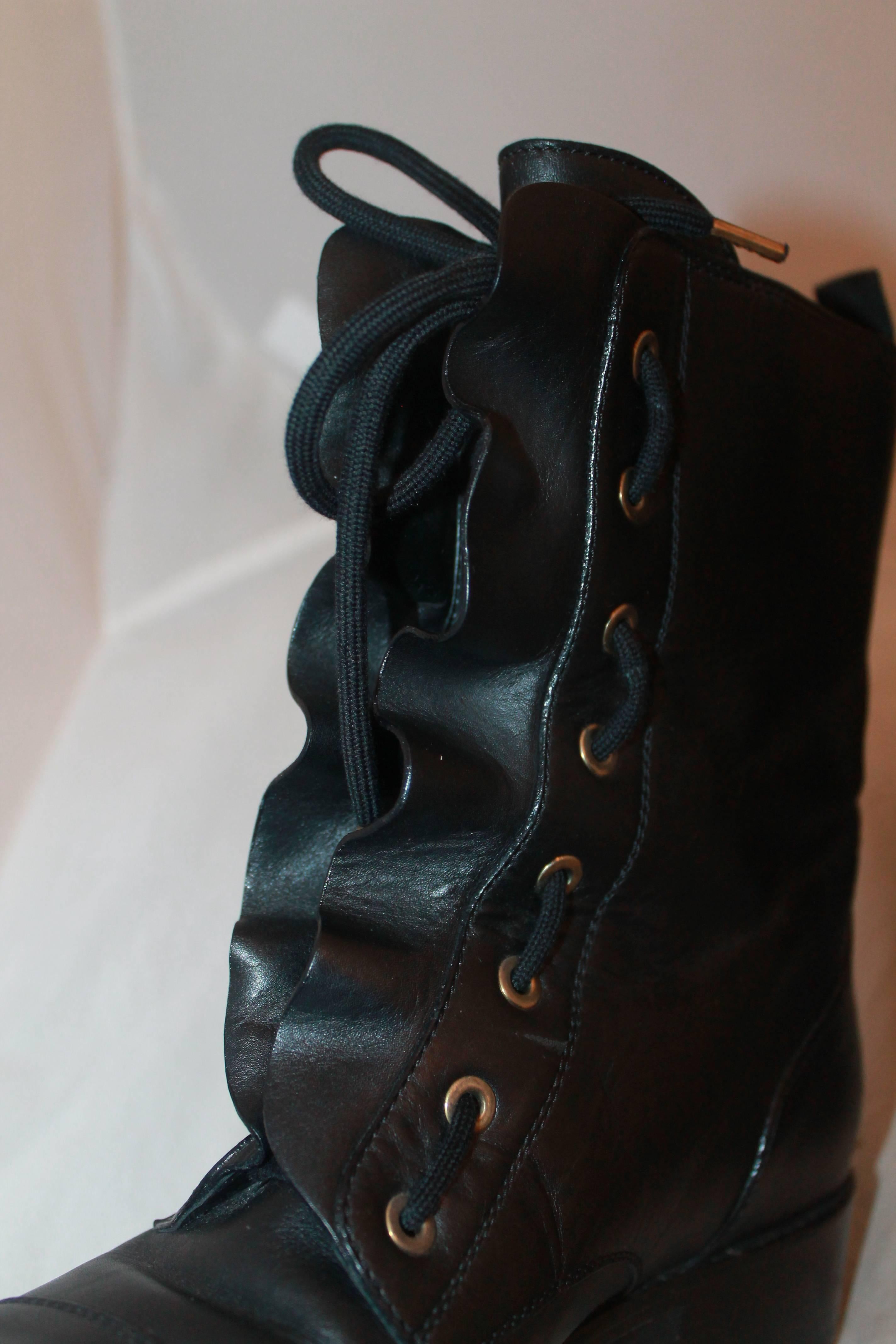Valentino Black Leather Ruffle Combat Boots - 38 - Retail: $1200.  These incredible boots are in excellent condition; they have never been worn, but they have some minor wear visible on the left toe and the right heel.  They feature a lovely black