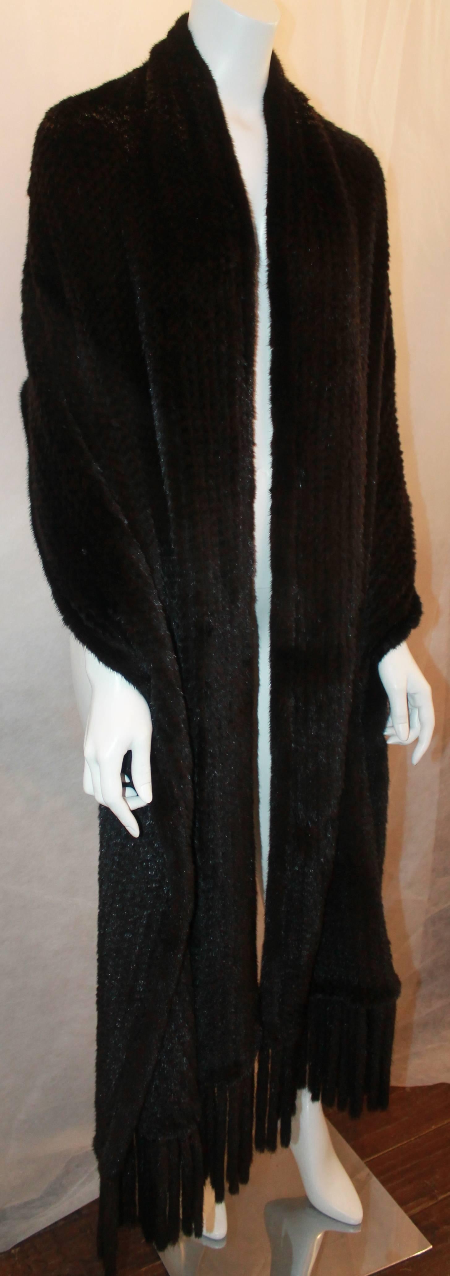Dennis Basso Black Knitted Mink Stole w/ Tassels.  This beautiful stole is in excellent condition.  It is very long and versatile as to how you wear it.  It features a gorgeous, soft knitted mink.

Measurements:
Width: 22