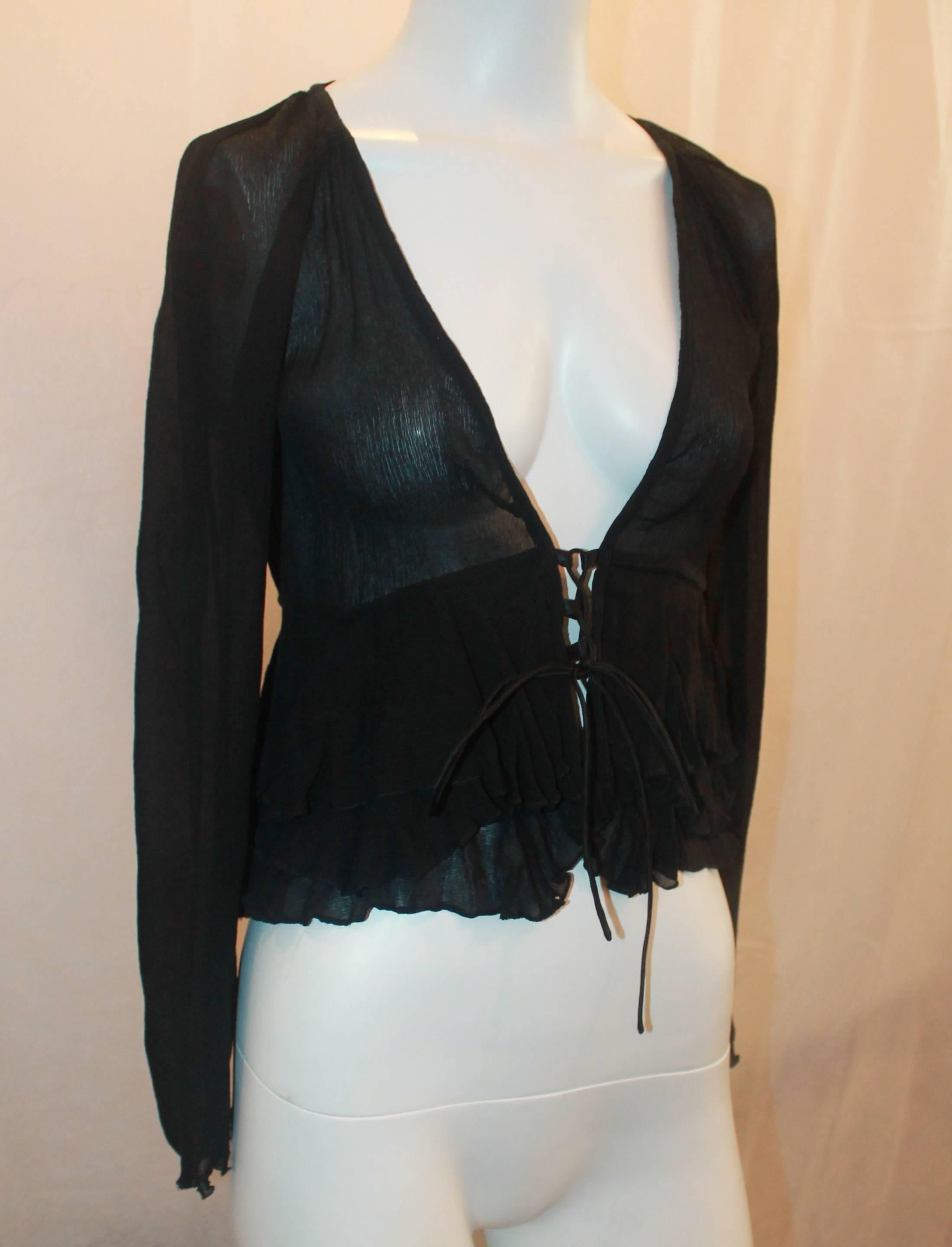 Gucci Black Silk Long Sleeve Blouse w/ Plunging Neckline - S.  This feminine top is in excellent condition.  It features a lovely black silk fabric, a plunging neckline, a lace-up tie closure, and tiered ruffles at the