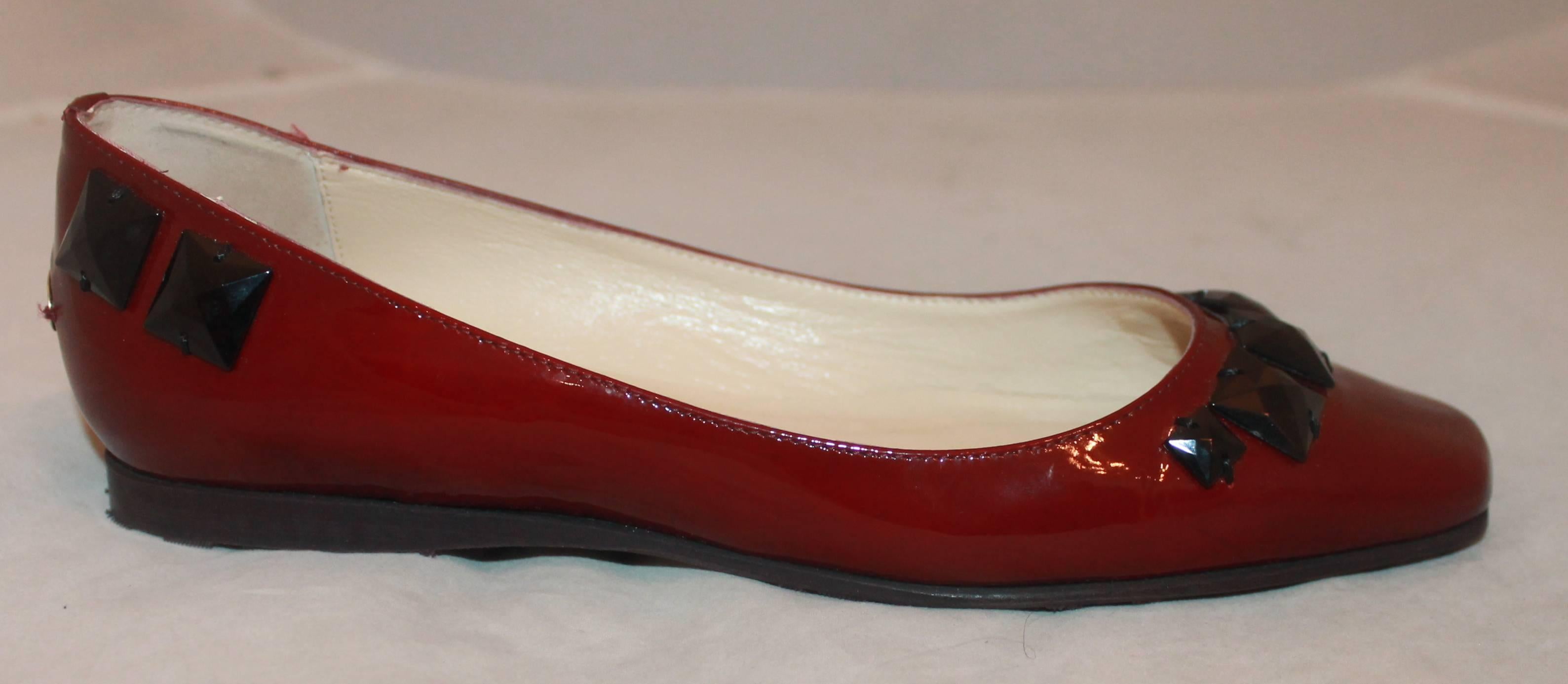 Jimmy Choo Red Patent Flats w/ Black Stone Beads - 37.  These lovely flats are in excellent condition with little or no wear to the sole, they were possibly never worn.  They feature a beautiful red patent exterior, black stone beads, a square toe,