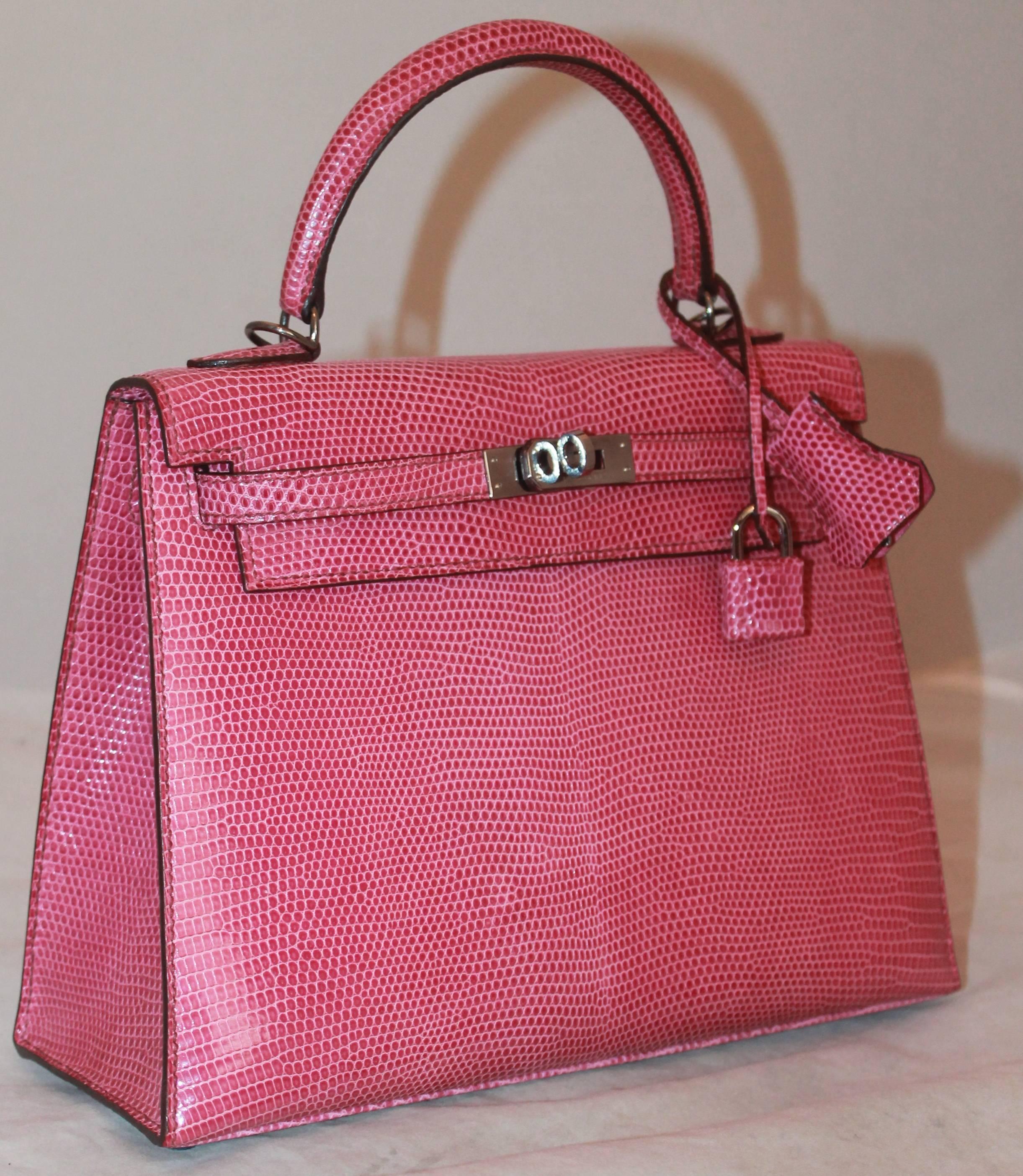 Hermes Pink Lizard Kelly w/ Lock & Key & Detachable Strap - 25cm - SHW.  This gorgeous Hermes Kelly is in excellent condition with only a slightly lighter spot on the front.  It features a gorgeous pink dyed lizard skin exterior, a lock and key, a