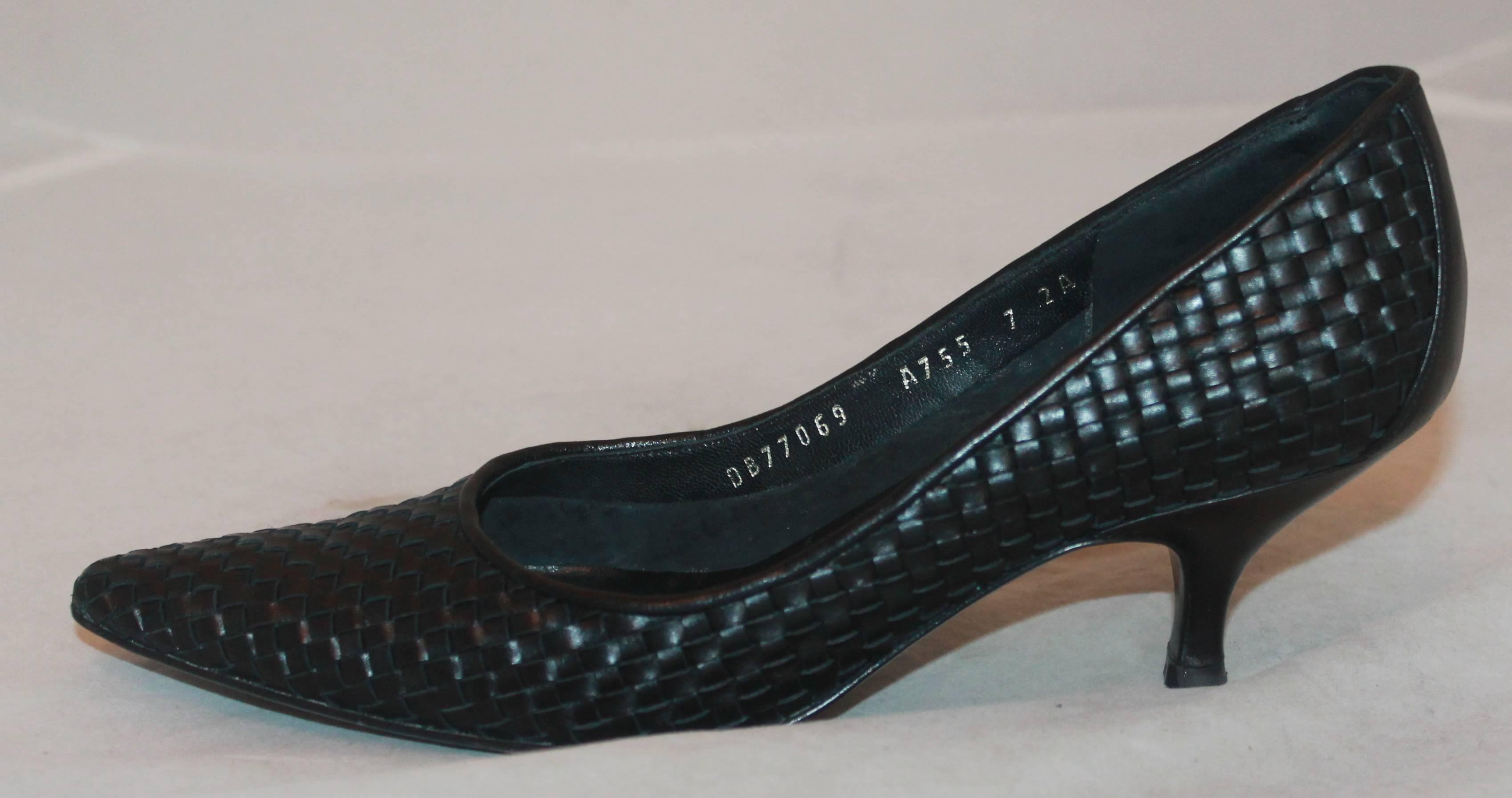 Salvatore Ferragamo Black Woven Leather Pump - 7AA.  These shoes are in excellent condition with only visible wear to the soles.  They feature a lovely black leather, an intricate woven pattern throughout, a rounded pointed toe, and a kitten