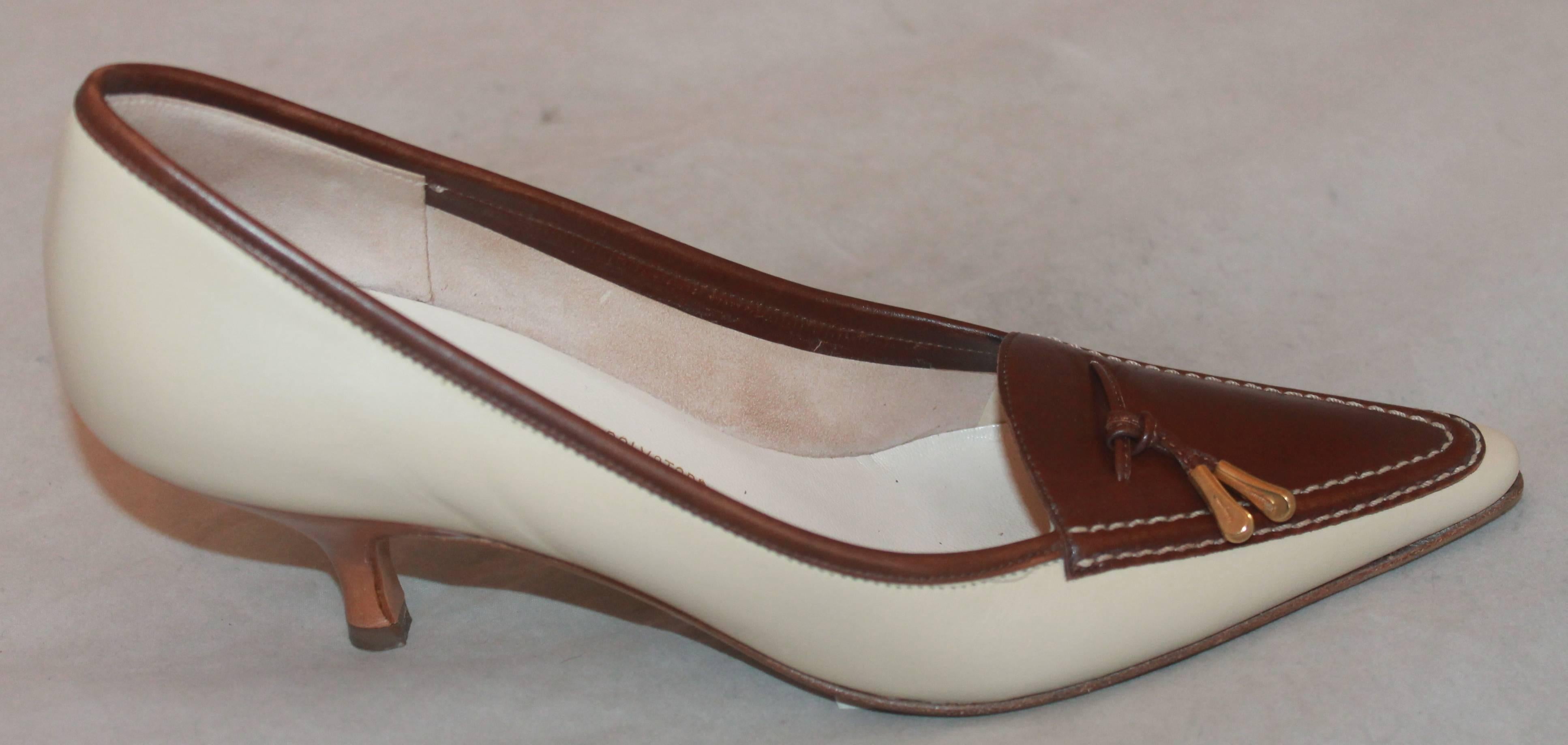 Salvatore Ferragamo Creme Loafer-Style Pumps w/ Brown Trim & Gold Tassel - 7AA.  These classy shoes are in excellent condition.  They feature a lovely crème leather, a brown leather trim, a classic loafer-style, kitten heels, and a brown leather