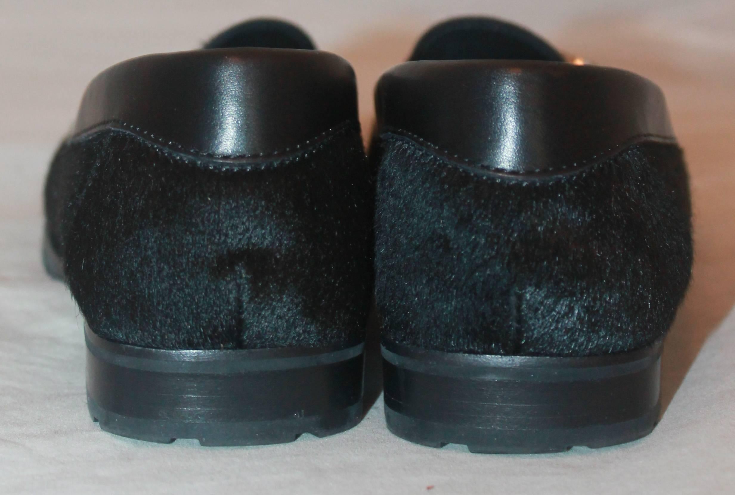 black loafers with silver buckle