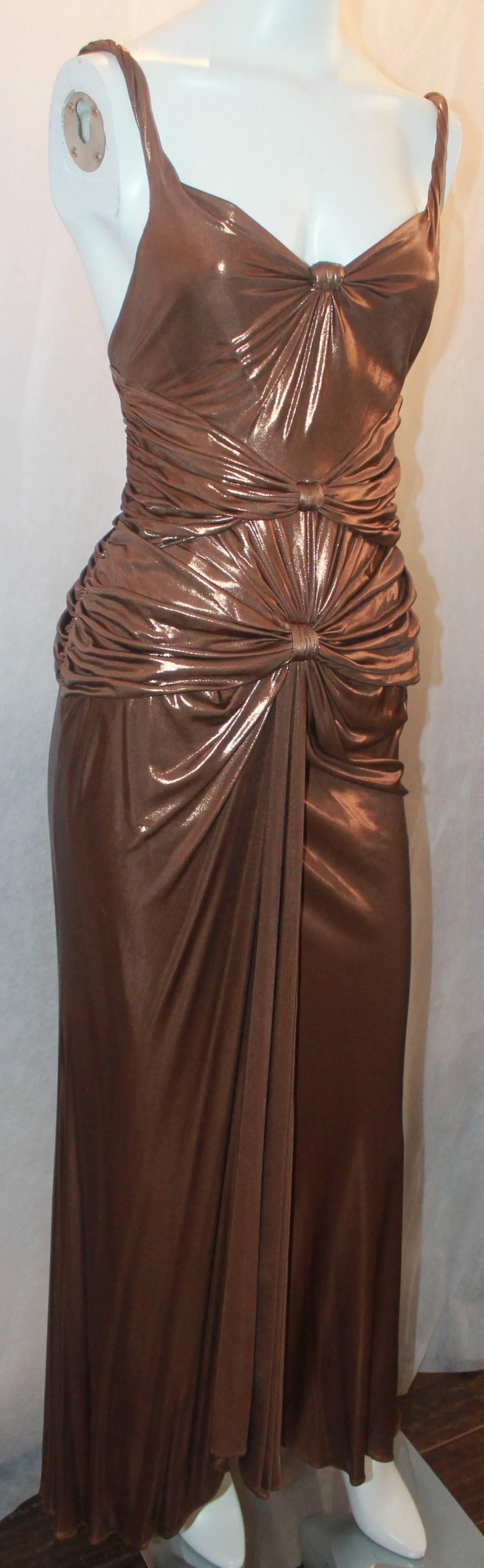 Emanuel Ungaro  Bronze Silk Lame Ruched Gown - S. This gorgeous gown is in excellent condition and has 3 ruched gatherings in the front with spaghetti straps. The gown has a draped look making it look very exotic.

Measurements:
Bust-31