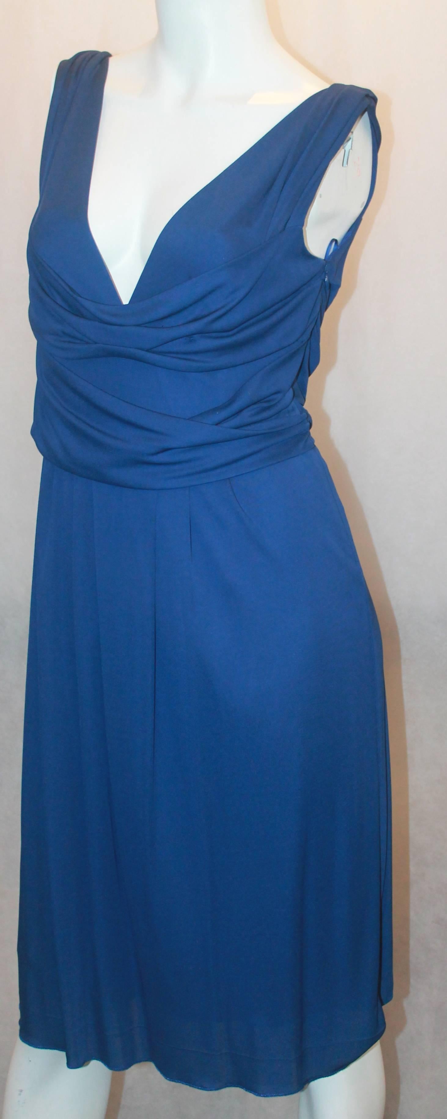 Moschino Blue Matte Sleeveless Jersey Dress - 8.  This lovely dress is in excellent condition.  It features a feminine blue matte jersey material, a knee length hem, a deep v neckline, and a waistband.  It is a simply beautiful