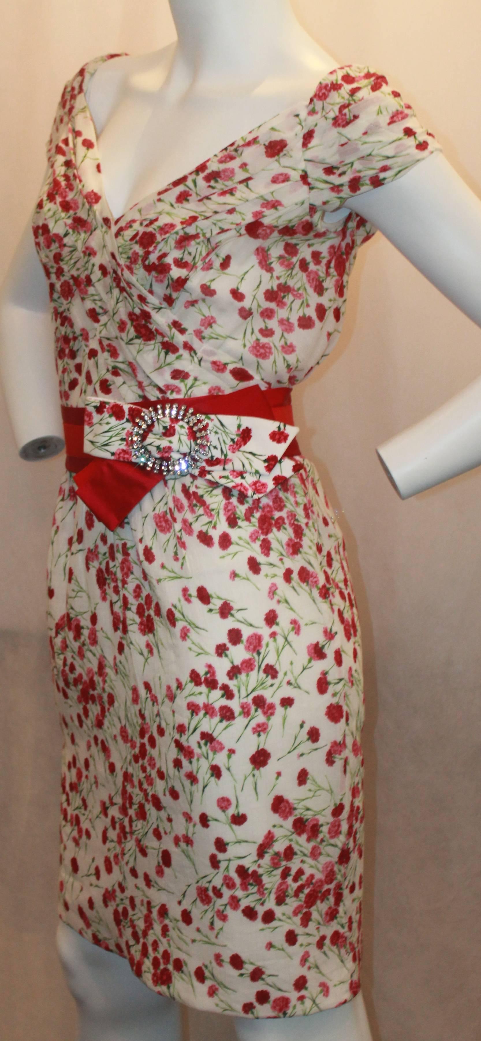 Dolce & Gabbana White Dress with Red Flower Print & Belt - 40. This dress is in excellent condition and is perfect for spring and summer! The belt is a grosgrain ribbon with red satin and a rhinestone buckle. The dress also is knee length and has