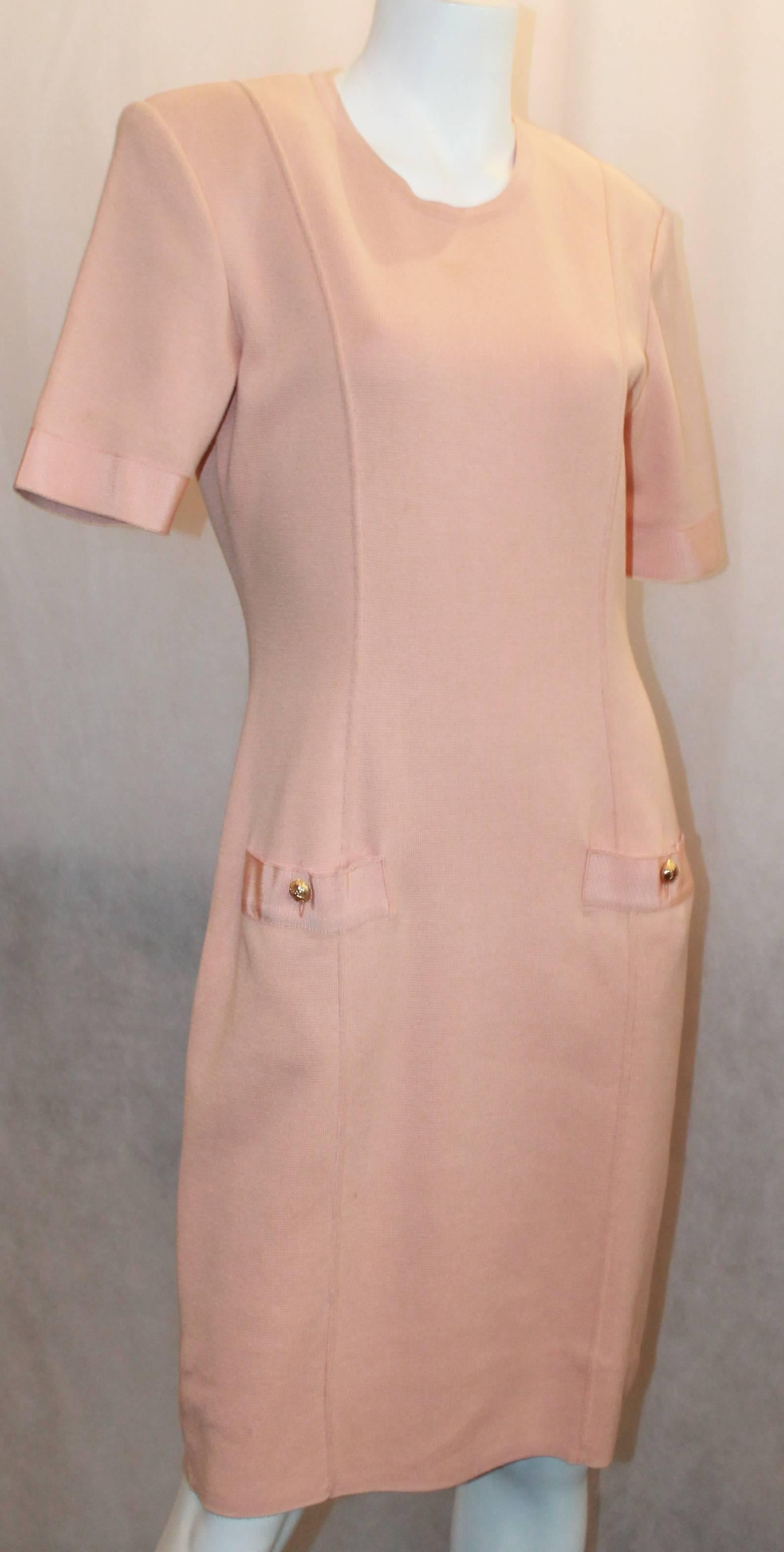 Salvatore Ferragamo Peach Cotton Knit Short Sleeve Shift Dress - Medium.  This lovely dress is in excellent condition.  It features a feminine peach cotton knit material, two pockets on the hips in the front with goldtone Ferragamo shoe buttons,